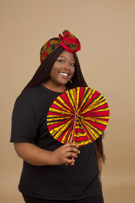 The expandable one-sized Keji i is African Print Reversible Fan is made from sustainably sourced 100% cotton Ankara wax print . It features a bold multi-colored bamboo tribal print in red, yellow and black pattern and a Leather Handle and fastener. Designed and Made in Ghana.