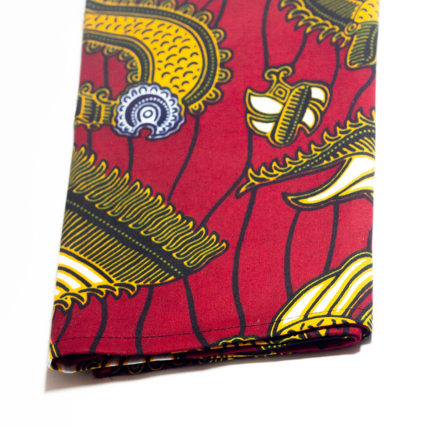 Red, yellow white and black African print head wrap fabric in a floral medallion pattern, made from sustainably sourced Ankara wax print.