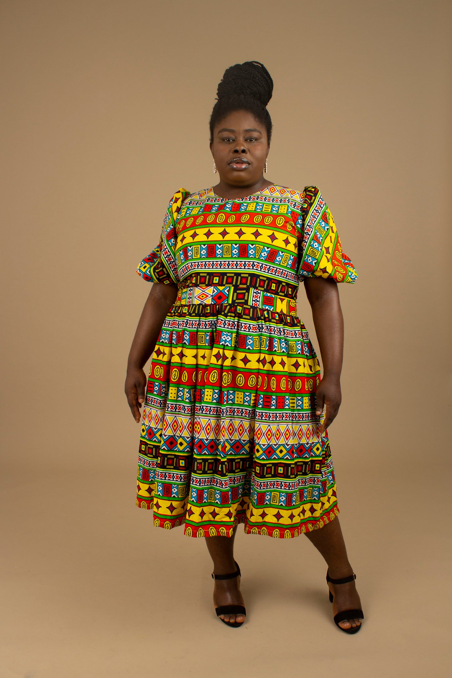 The Akala African Print Skater Dress is crafted from sustainable wax print and features two side pockets in a repeated multi-coloured geometric Kente pattern from cotton. Designed in England Made in Nigeria. Available in standard and plus sizes (UK 8-32).