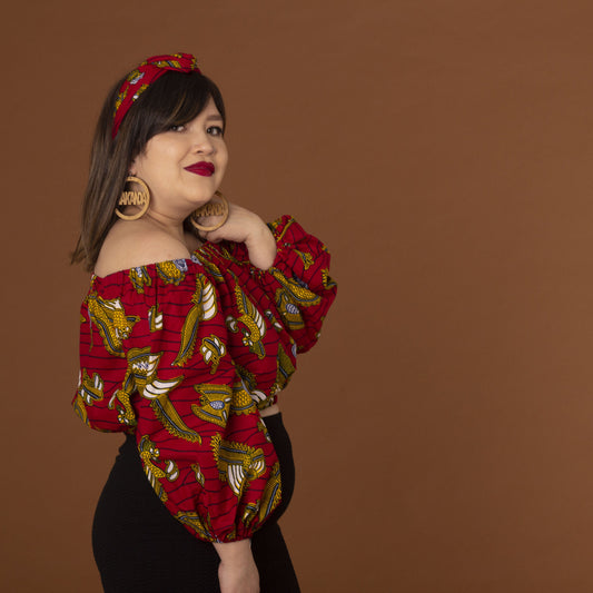 Red, yellow white and black African print head wrap tied as headband in a floral medallion pattern, made from sustainably sourced Ankara wax print.