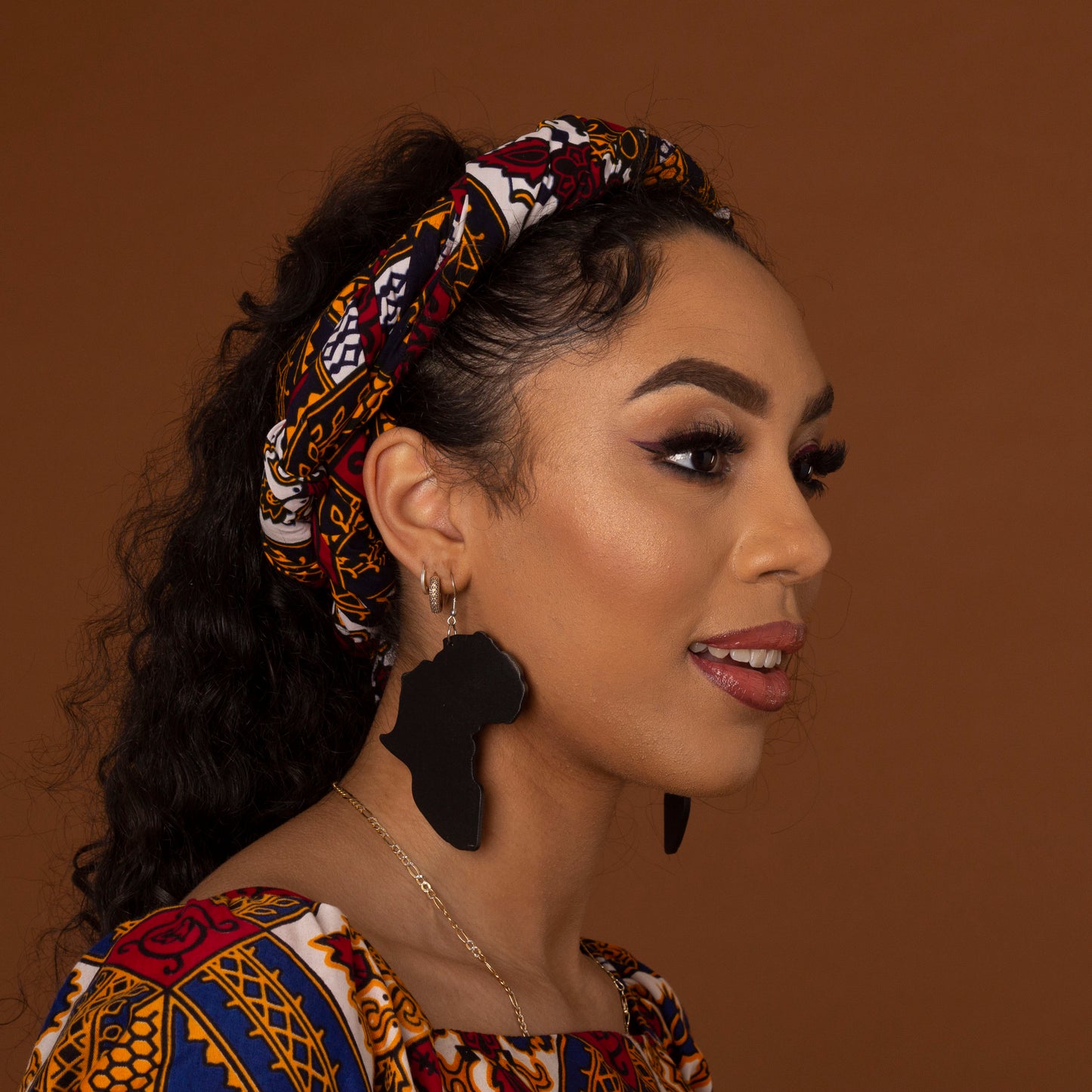 Black wooden earrings featuring the shape of the map of Africa