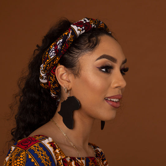 Black wooden earrings featuring the shape of the map of Africa