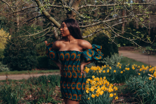 Adetayo African Ankara wax printed fabric in a green, orange and black circle geo-shaped pattern featured Midi-length dress, off-shoulder puff sleeve wit fitted bodice with a fitted elasticated waist reverse and closed back.