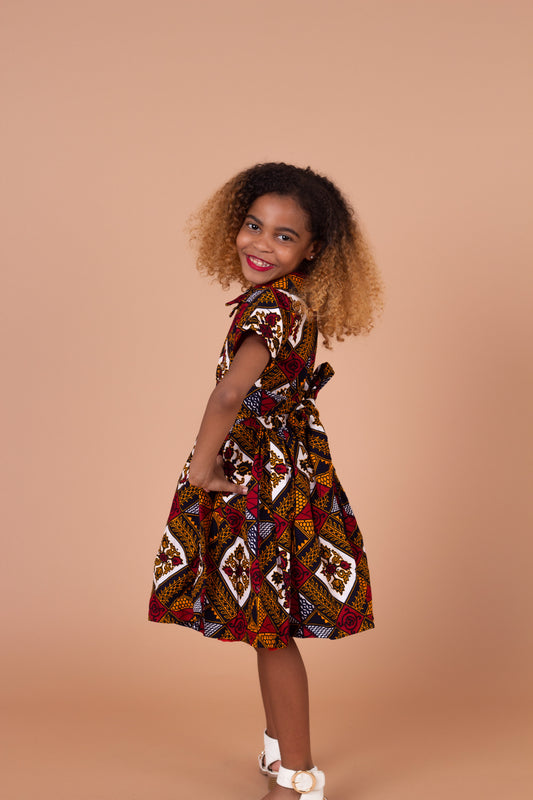 Ankara wax printed Knee length flared belted dress with short sleeves and collared neckline in Red, yellow, white and black Squared African medallion pattern.