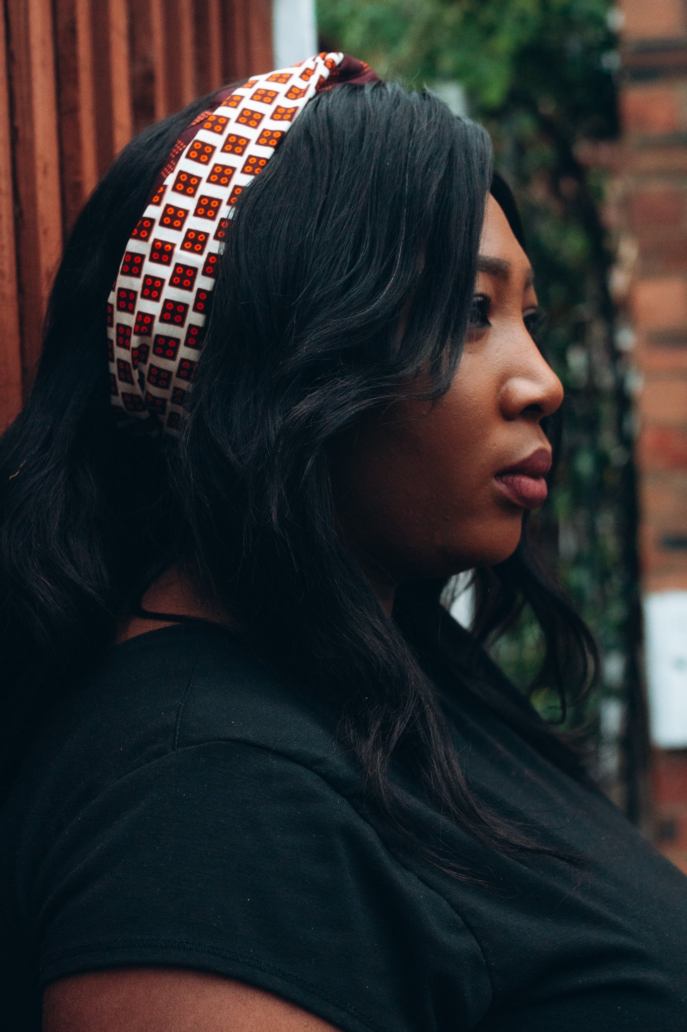 Brown, orange and white African print head wrap tied as headband in a titled squared brick pattern, made from sustainably sourced Ankara wax print.
