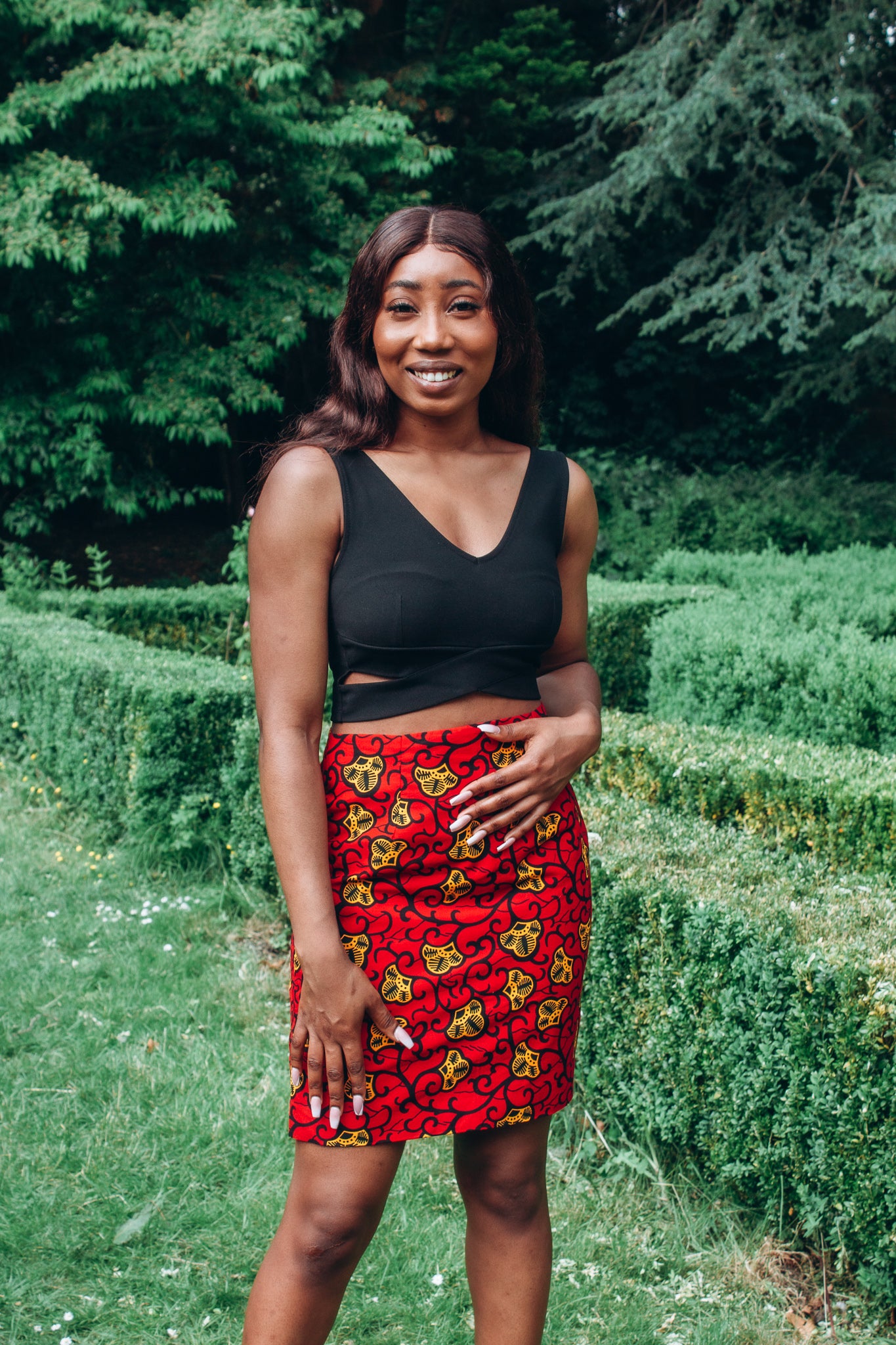 Red, yellow and black African print high waisted pencil skirt in a floral pattern, made from sustainably sourced Ankara wax print.