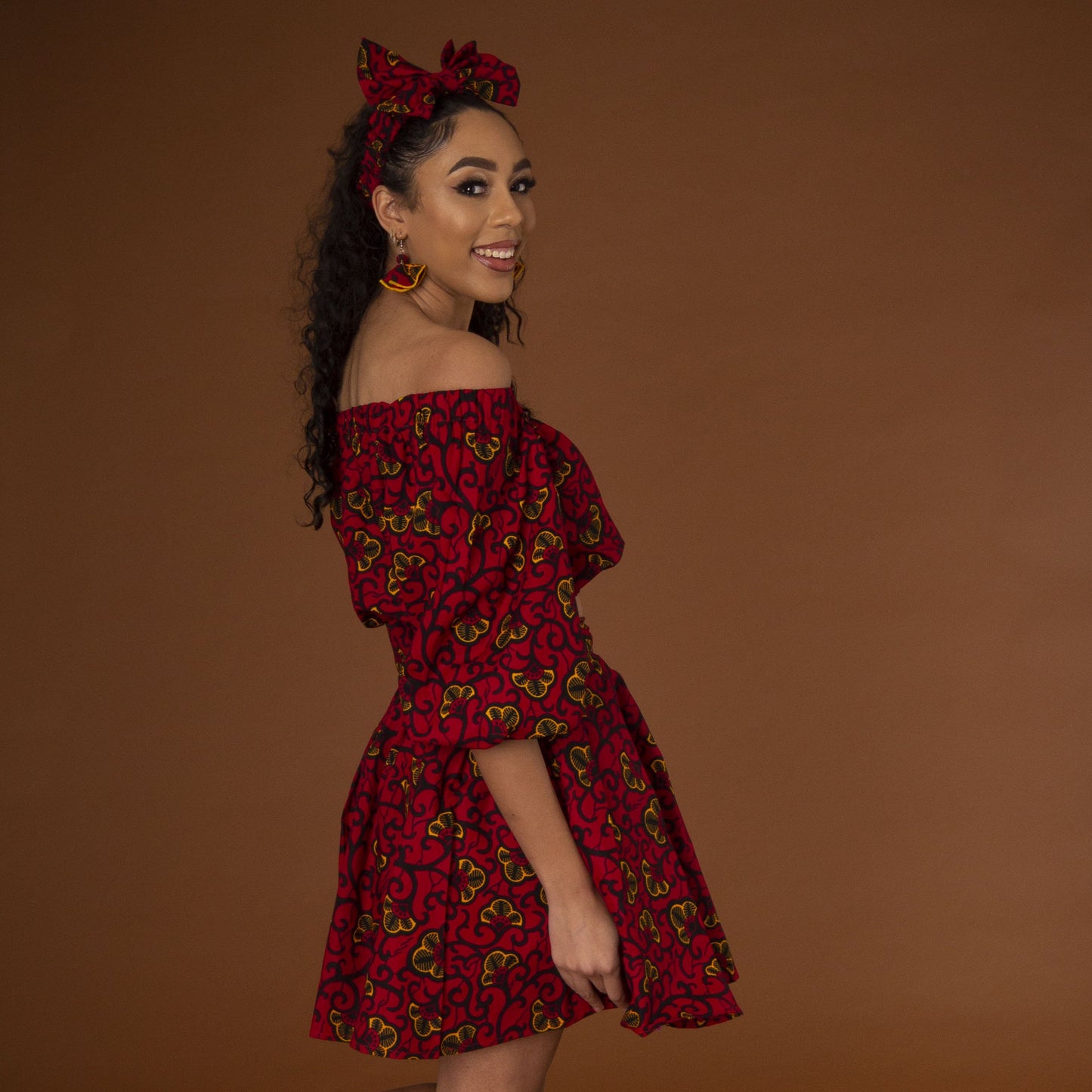 Red, yellow and black African print high waisted pleated skater skirt in a floral pattern, made from sustainably sourced Ankara wax print.