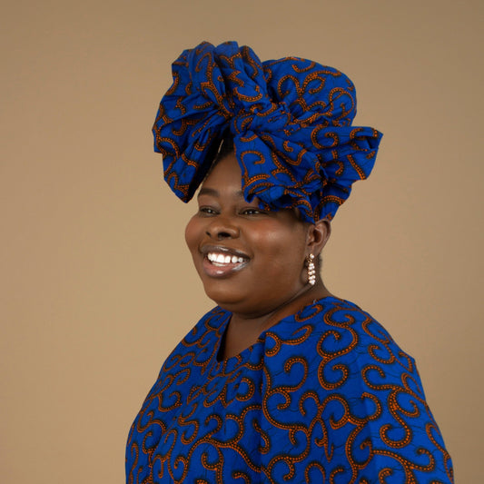 The Ore African Print Head Wrap is a lightweight African Print hair accessory that is ethically produced sourced cotton. The Ankara wax print in a gorgeous blue and orange swirling African Print pattern. Designed in England Made in Nigeria, Available Sizing: Small - 44" x 9" / 109cm x 22cm Large - 70" x 22" / 182cm x 55cm.