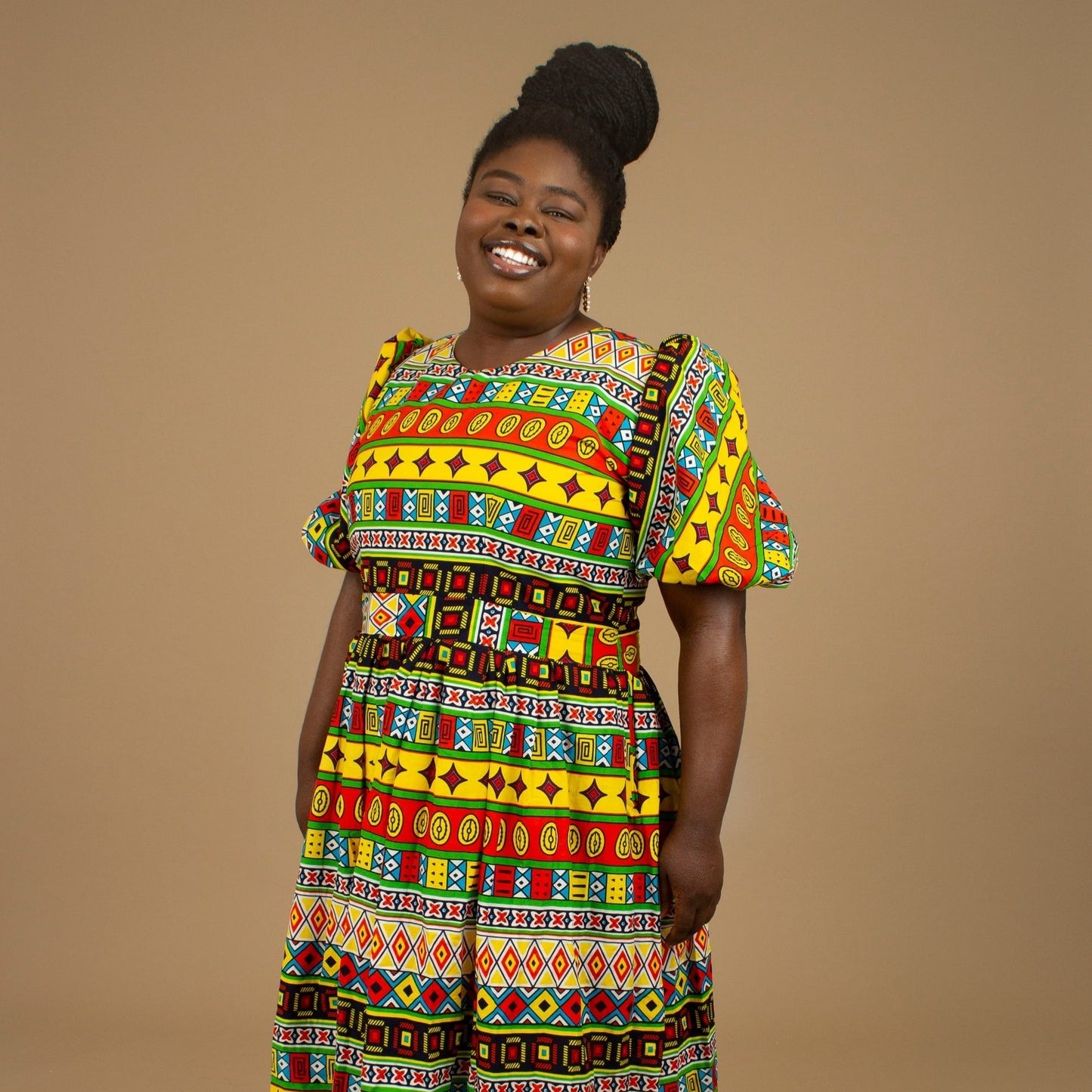 The Akala African Print Skater Dress is crafted from sustainable wax print and features two side pockets in a repeated multi-coloured geometric Kente pattern from cotton. Designed in England Made in Nigeria. Available in standard and plus sizes (UK 8-32).