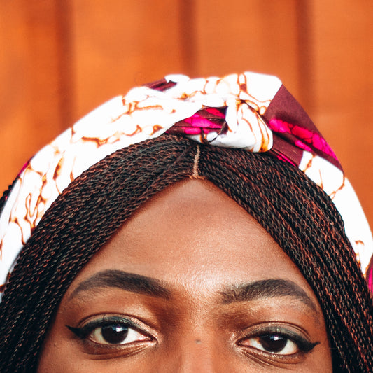 Purple, brown, and white African print head wrap tied as headband in a granite pattern, made from sustainably sourced Ankara wax print.