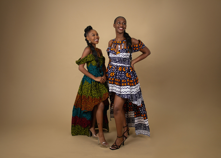 Two beautiful women wearing stunning dresses from The Legacy Collection