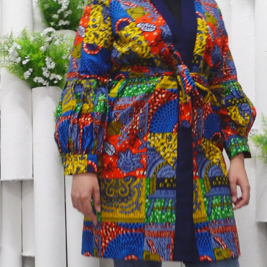 The Sade Patchwork Kimono Jacket is a vibrant multi-coloured mandala patchwork African wax Printed pattern jacket on sustainable cotton. Designed in England Made in Nigeria, Available in standard and plus sizes (UK 8-32). 