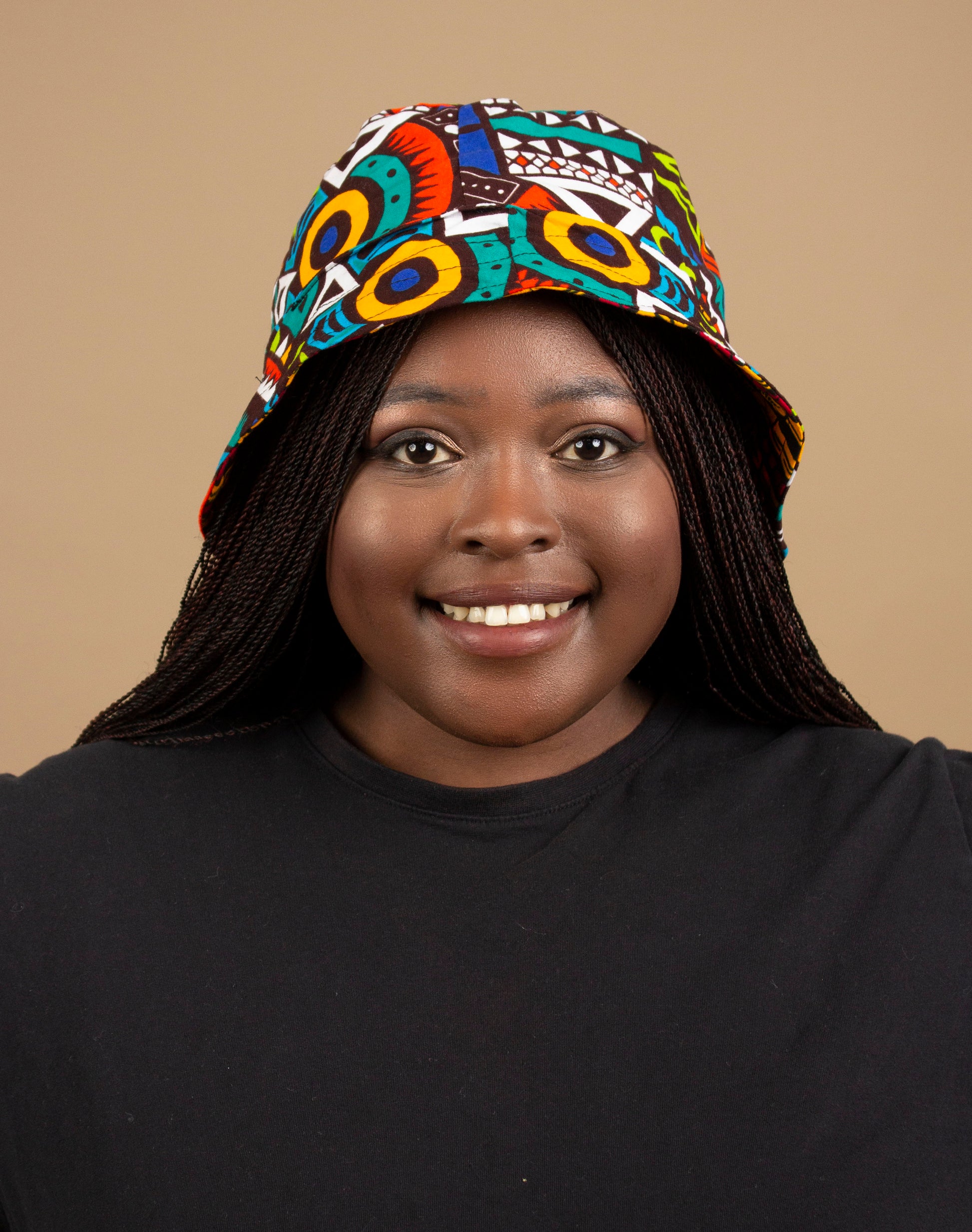 The one-sized Keji African Print Reversible Bucket Hat is made from sustainably sourced Ankara wax printed cotton in two sustainably sourced wax printed cottons - Keji & the other side is Tayo. Designed in England Made in Nigeria. 