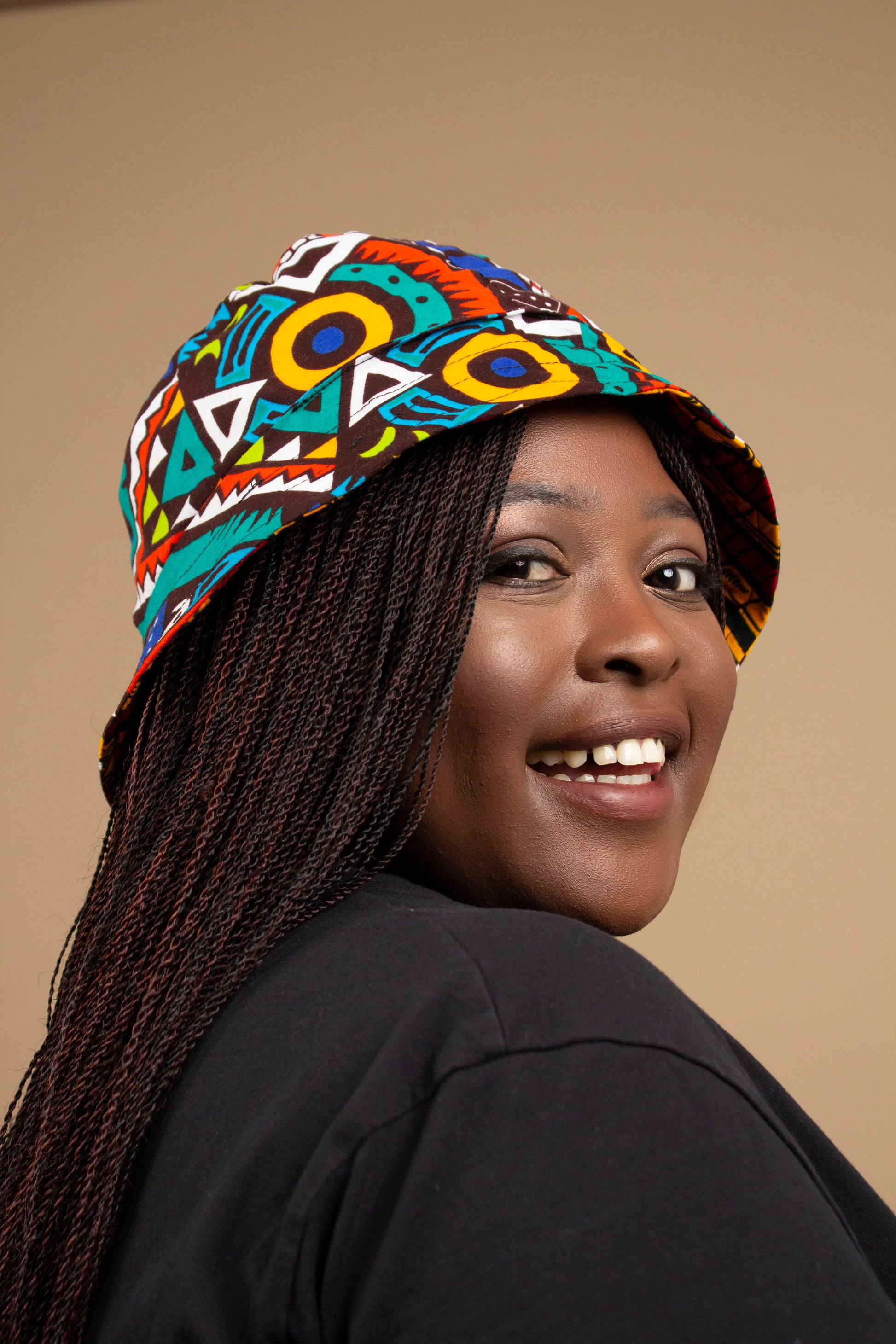 The one-sized Keji African Print Reversible Bucket Hat is made from sustainably sourced Ankara wax printed cotton in two sustainably sourced wax printed cottons - Keji & the other side is Tayo. Designed in England Made in Nigeria. 