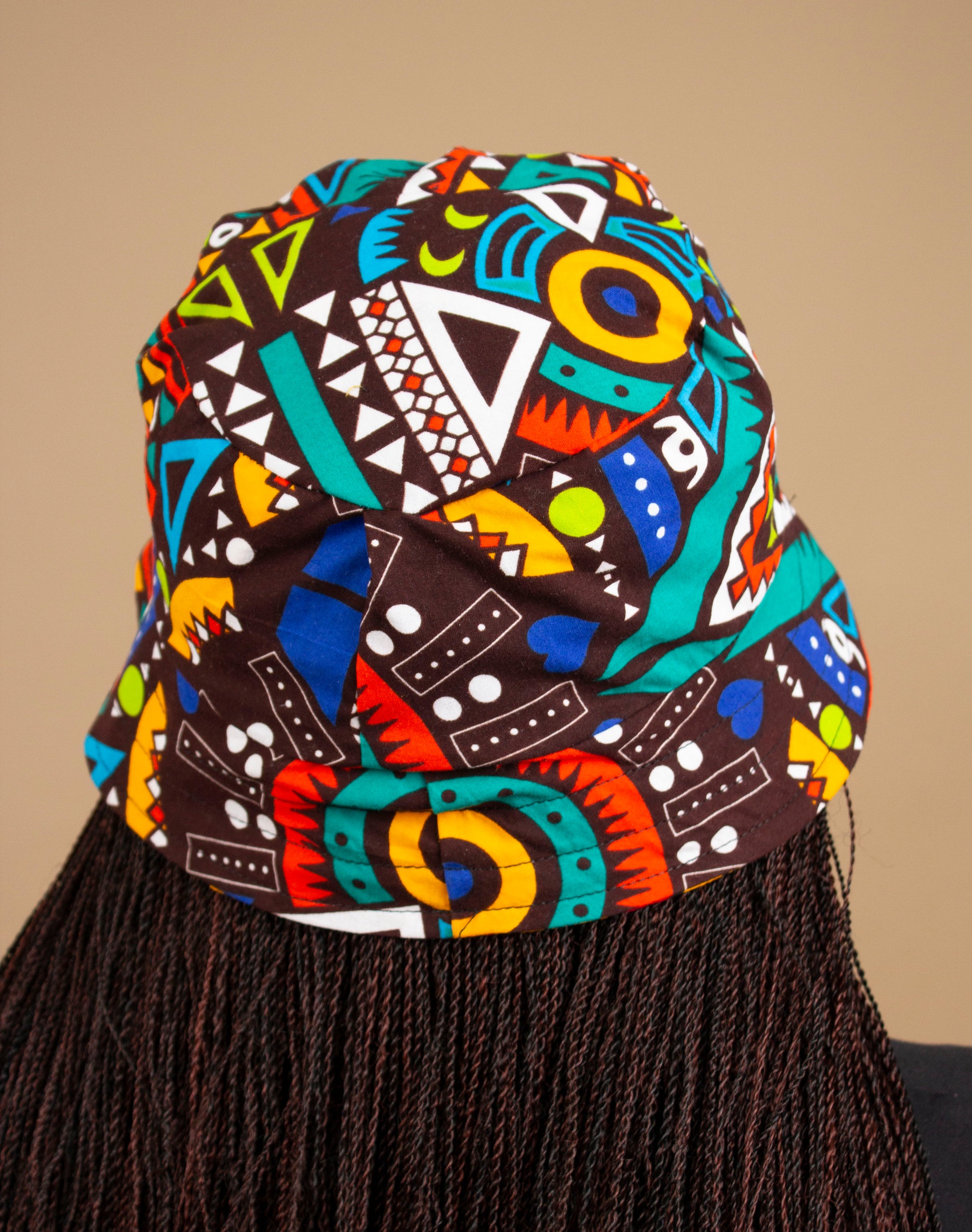 The one-sized Keji African Print Reversible Bucket Hat is made from sustainably sourced Ankara wax printed cotton in two sustainably sourced wax printed cottons - Keji & the other side is Tayo. Designed in England Made in Nigeria. 