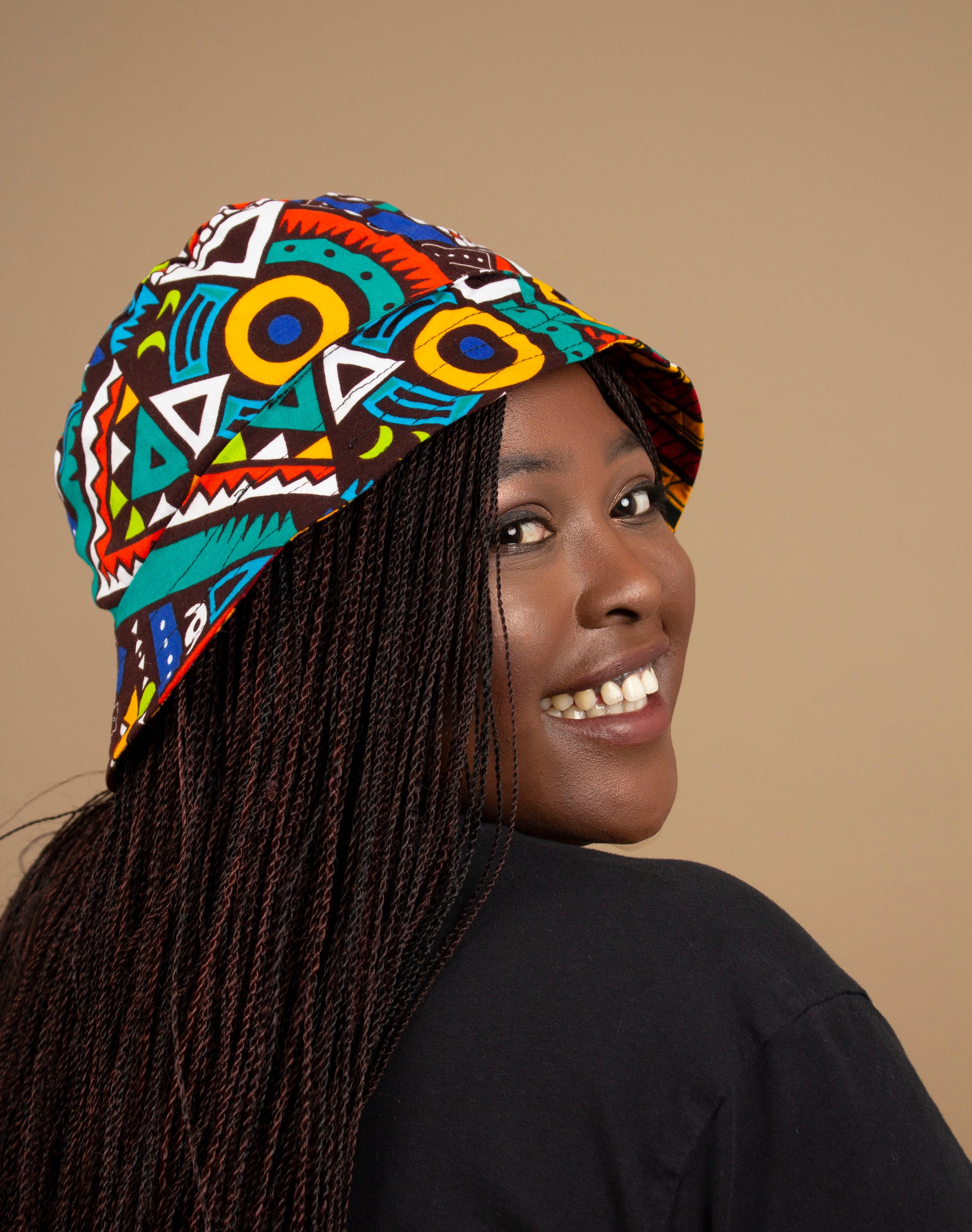 The one-sized Keji African Print Reversible Bucket Hat is made from sustainably sourced Ankara wax printed cotton in two sustainably sourced wax printed cottons - Keji & the other side is Tayo. Designed in England Made in Nigeria. 
