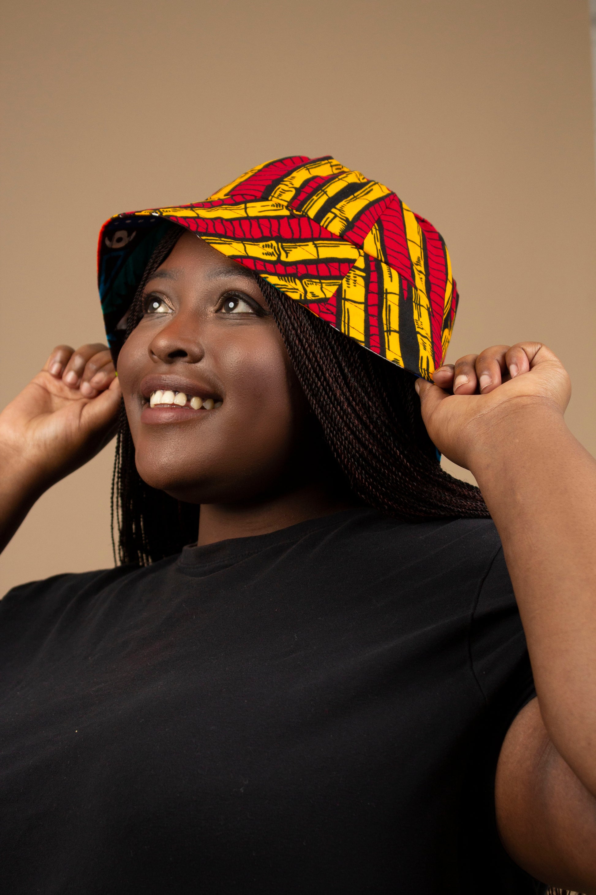 The one-sized Keji African Print Reversible Bucket Hat is made from sustainably sourced Ankara wax printed cotton in two sustainably sourced wax printed cottons - Keji & the other side is Tayo. Designed in England Made in Nigeria. 