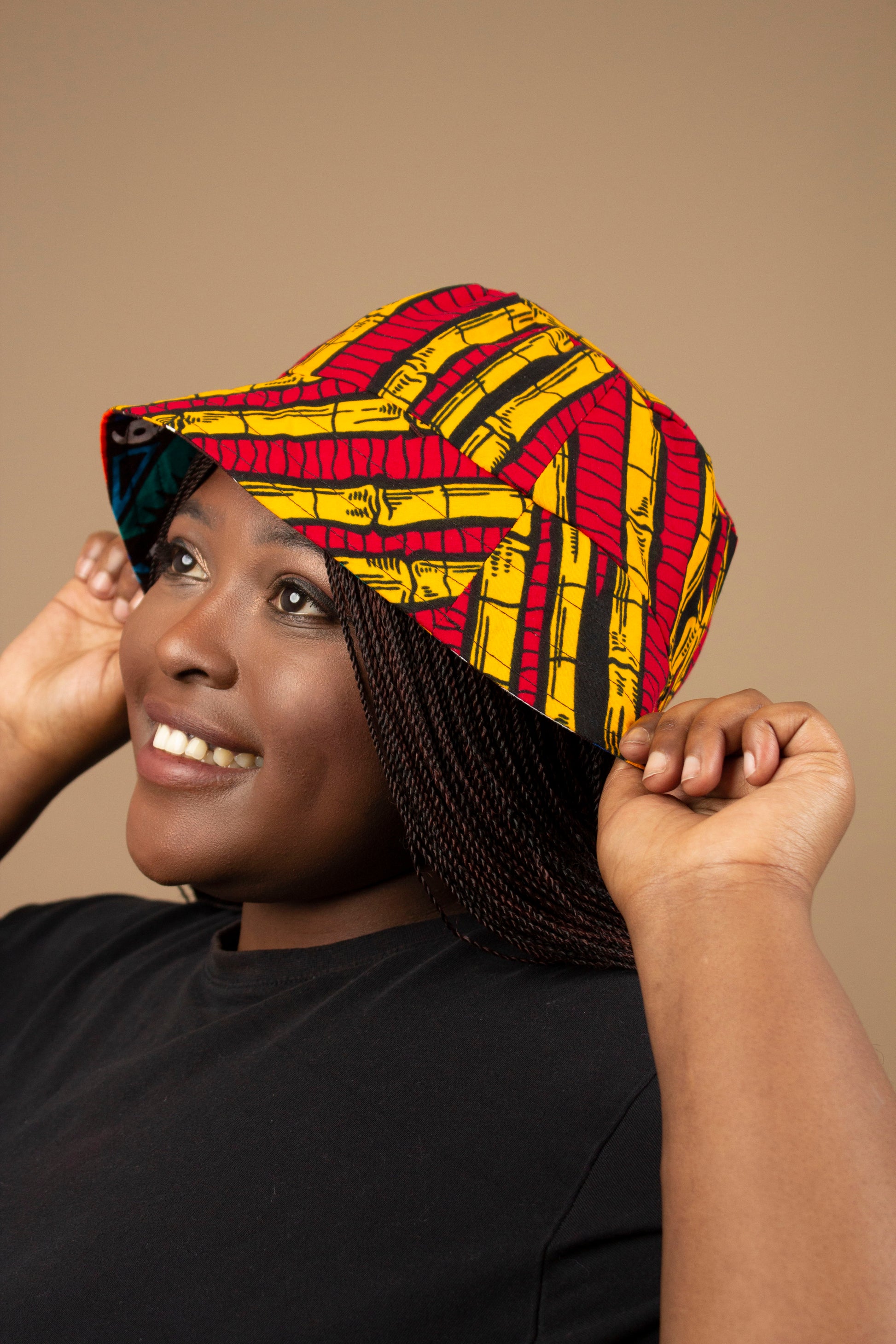 The one-sized Keji African Print Reversible Bucket Hat is made from sustainably sourced Ankara wax printed cotton in two sustainably sourced wax printed cottons - Keji & the other side is Tayo. Designed in England Made in Nigeria. 
