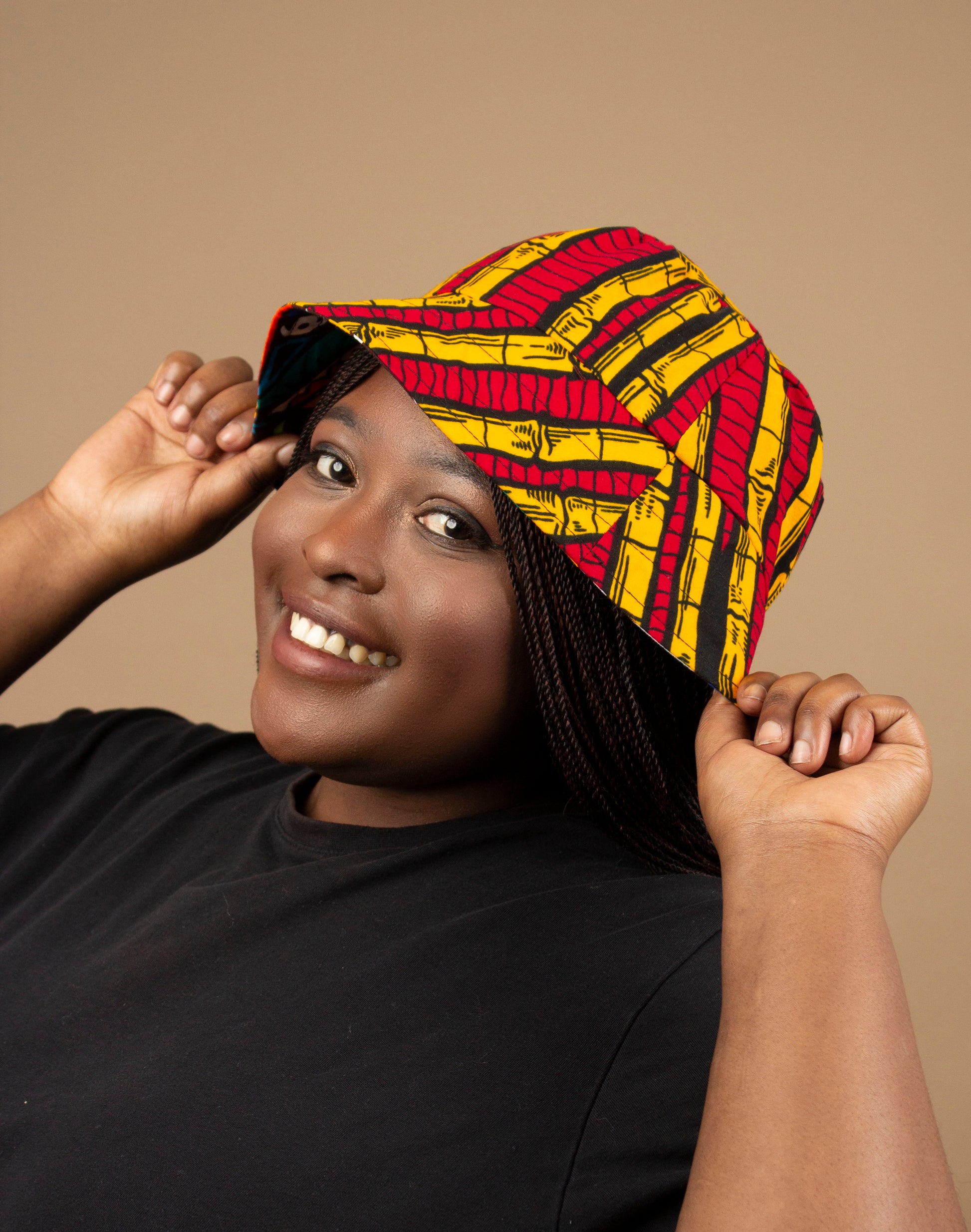 The one-sized Keji African Print Reversible Bucket Hat is made from sustainably sourced Ankara wax printed cotton in two sustainably sourced wax printed cottons - Keji & the other side is Tayo. Designed in England Made in Nigeria. 