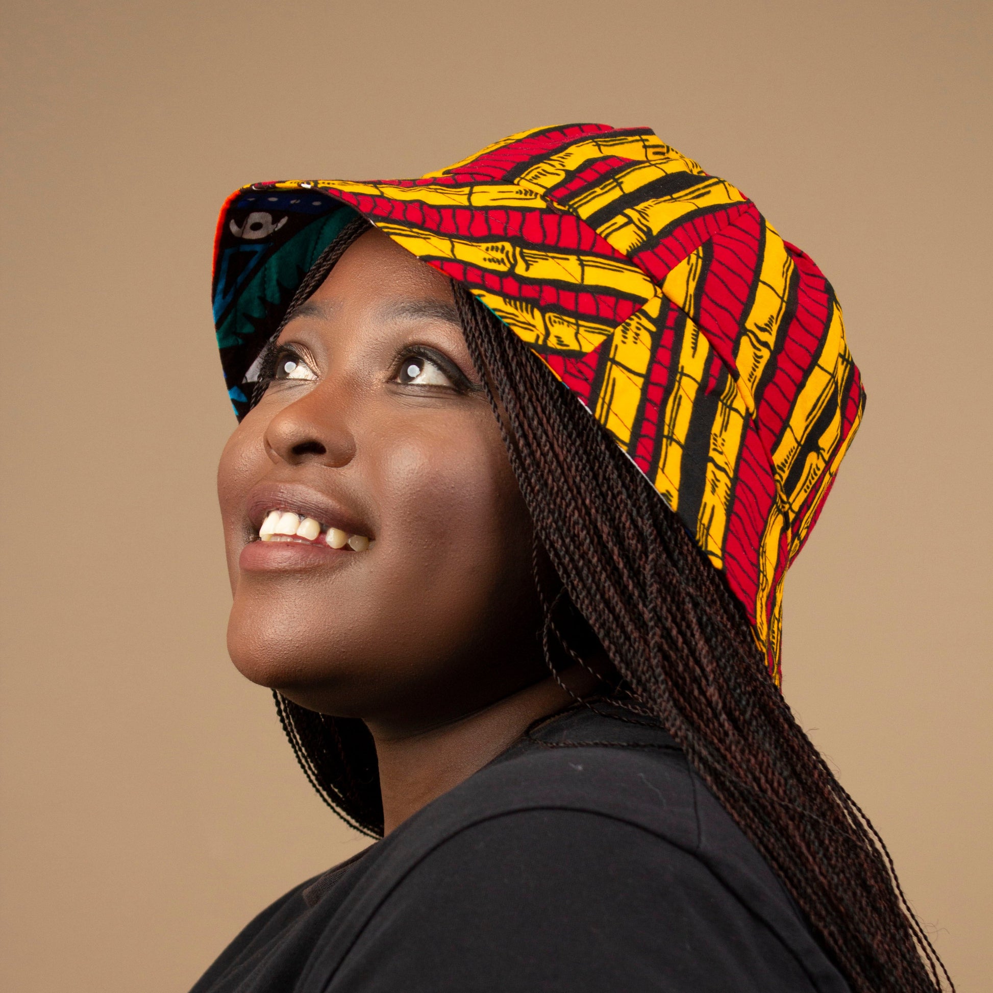 The one-sized Keji African Print Reversible Bucket Hat is made from sustainably sourced Ankara wax printed cotton in two sustainably sourced wax printed cottons - Keji & the other side is Tayo. Designed in England Made in Nigeria. 