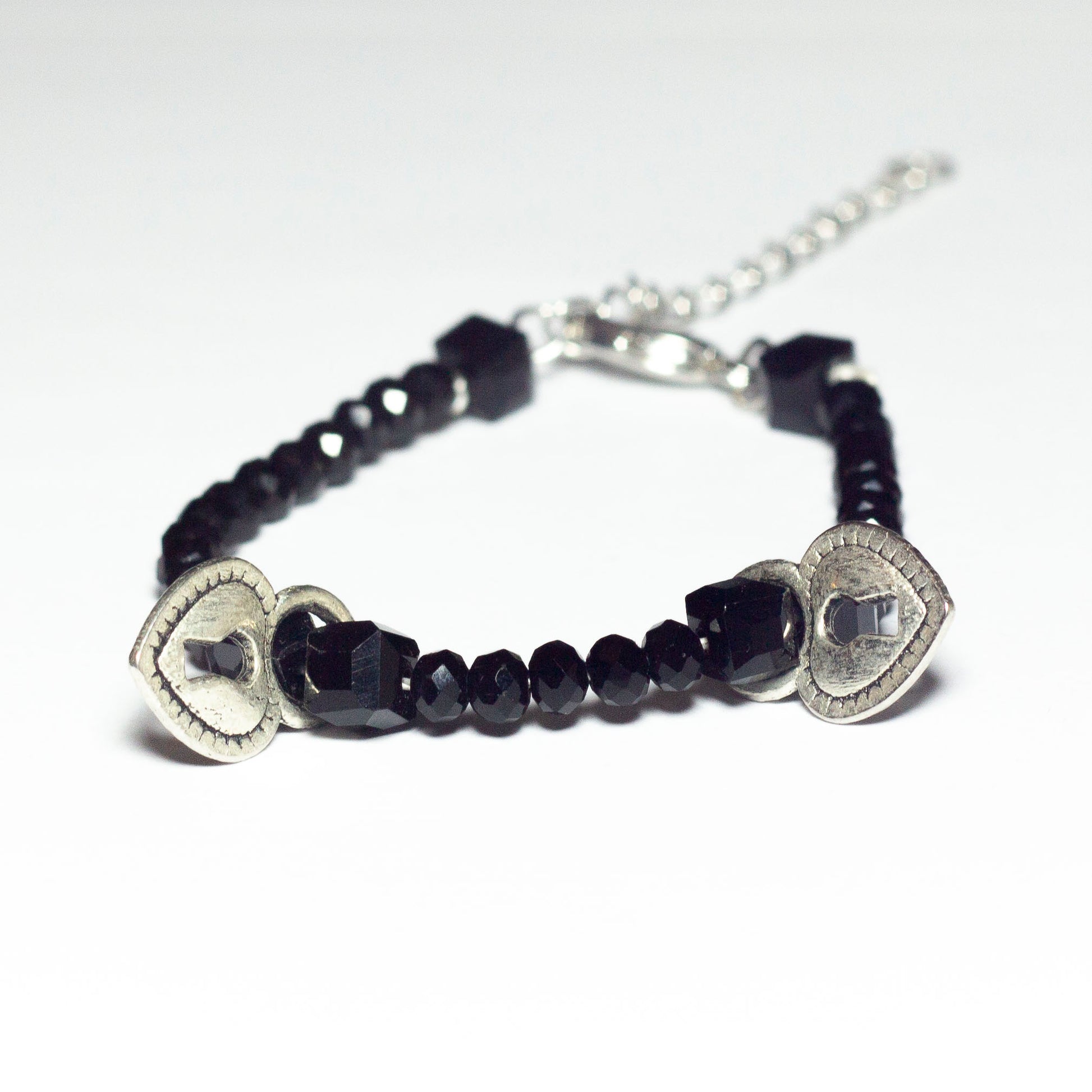 black beaded bracelet with heart locket pendants and chain clasp