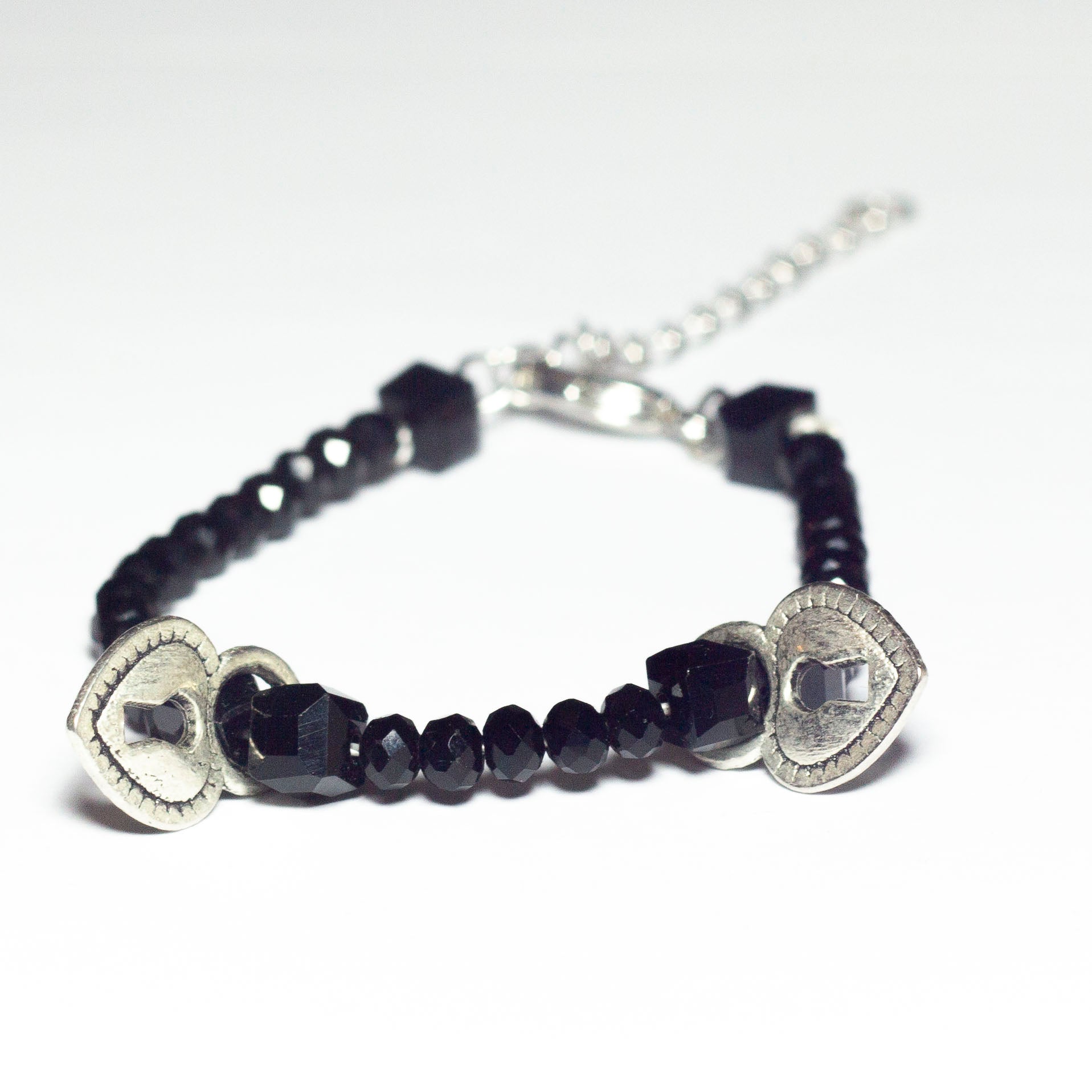 black beaded bracelet with heart locket pendants and chain clasp