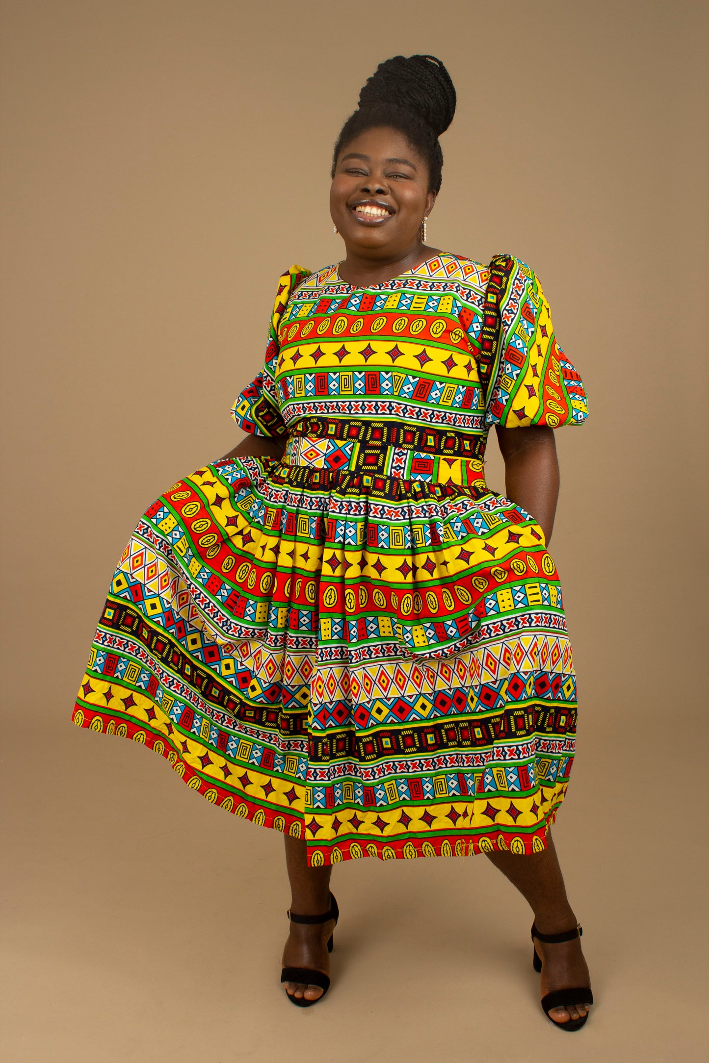 The Akala African Print Skater Dress is crafted from sustainable wax print and features two side pockets in a repeated multi-coloured geometric Kente pattern from cotton. Designed in England Made in Nigeria. Available in standard and plus sizes (UK 8-32).