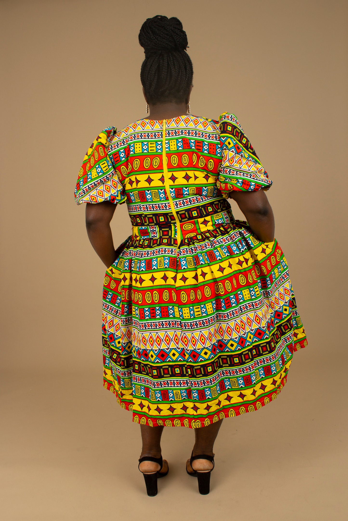 The Akala African Print Skater Dress is crafted from sustainable wax print and features two side pockets in a repeated multi-coloured geometric Kente pattern from cotton. Designed in England Made in Nigeria. Available in standard and plus sizes (UK 8-32).