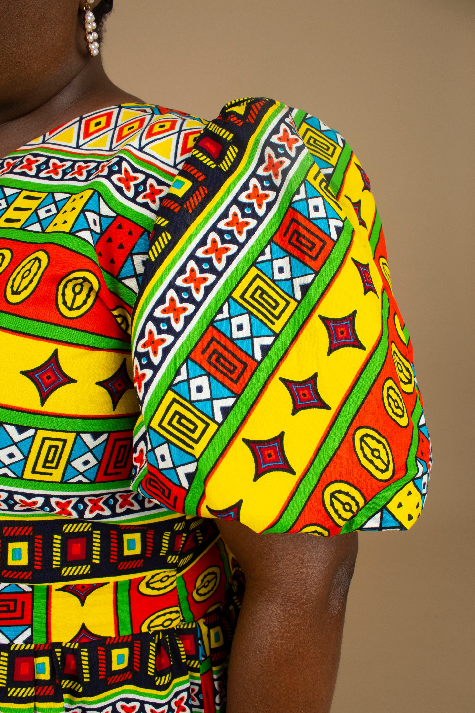 The Akala African Print Skater Dress is crafted from sustainable wax print and features two side pockets in a repeated multi-coloured geometric Kente pattern from cotton. Designed in England Made in Nigeria. Available in standard and plus sizes (UK 8-32).
