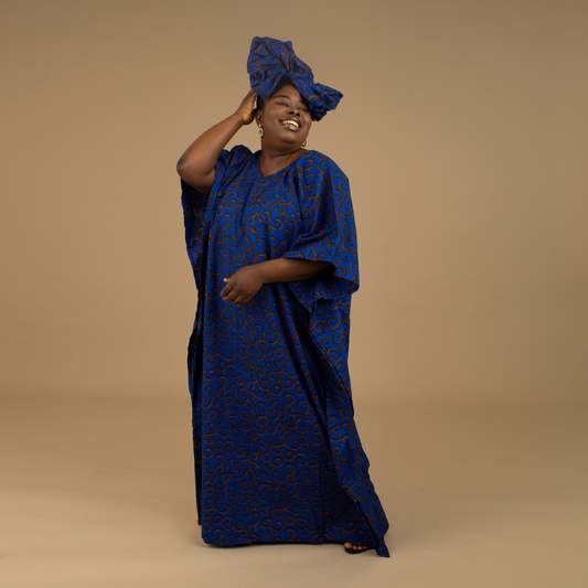 The Ore Floor Length lightweight African Print Kaftan Dress in Ankara wax print in a deep blue and orange swirling African Print pattern is ethically sourced cotton. Designed in England Made in Nigeria. 