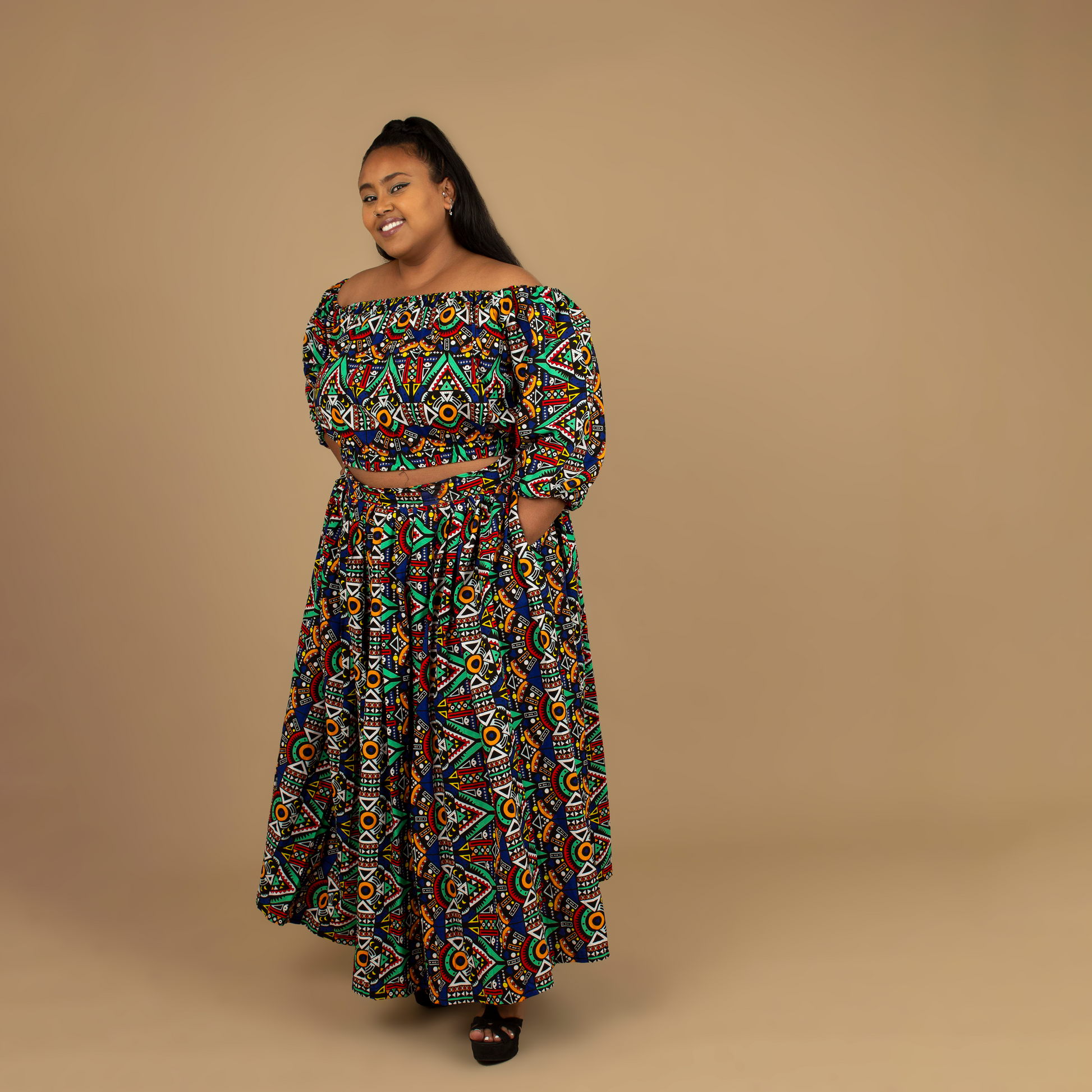 Ifemi African Maxi Skirt Two-piece Set with an elasticated crop top and maxi skirt in a vibrant Ankara wax, geometric multicolored pattern using sustainable ethically sourced Cotton, designed in England Made in Nigeria.