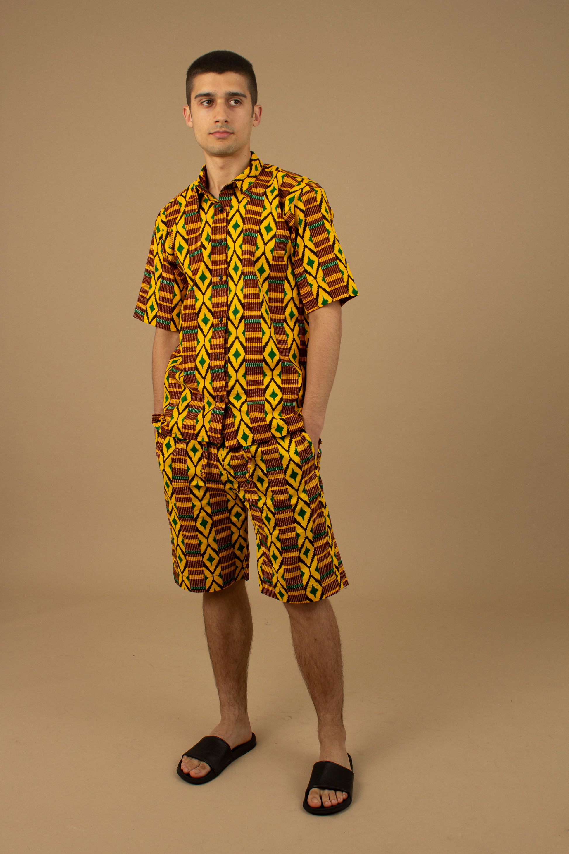 The Adina Kente African Print two- piece Button-Up shirt and Shorts in a striking Diamond geometric kente pattern in  green, yellow and black made from sustainably sourced 100% Cotton. Designed in England Made in Nigeria.