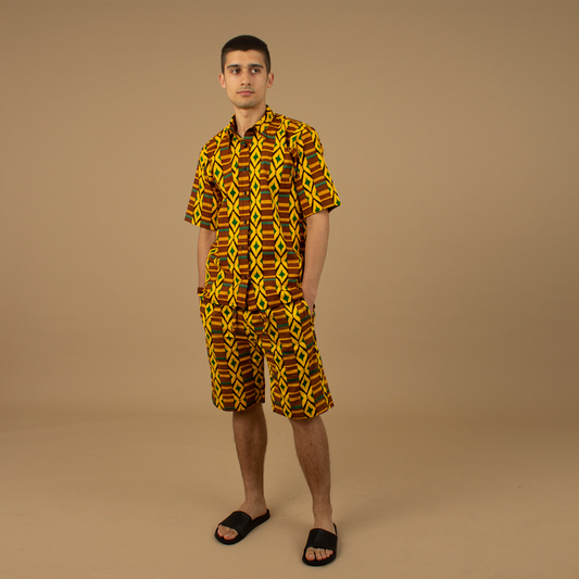 The Adina Kente African Print two- piece Button-Up shirt and Shorts in a striking Diamond geometric kente pattern in  green, yellow and black made from sustainably sourced 100% Cotton. Designed in England Made in Nigeria.