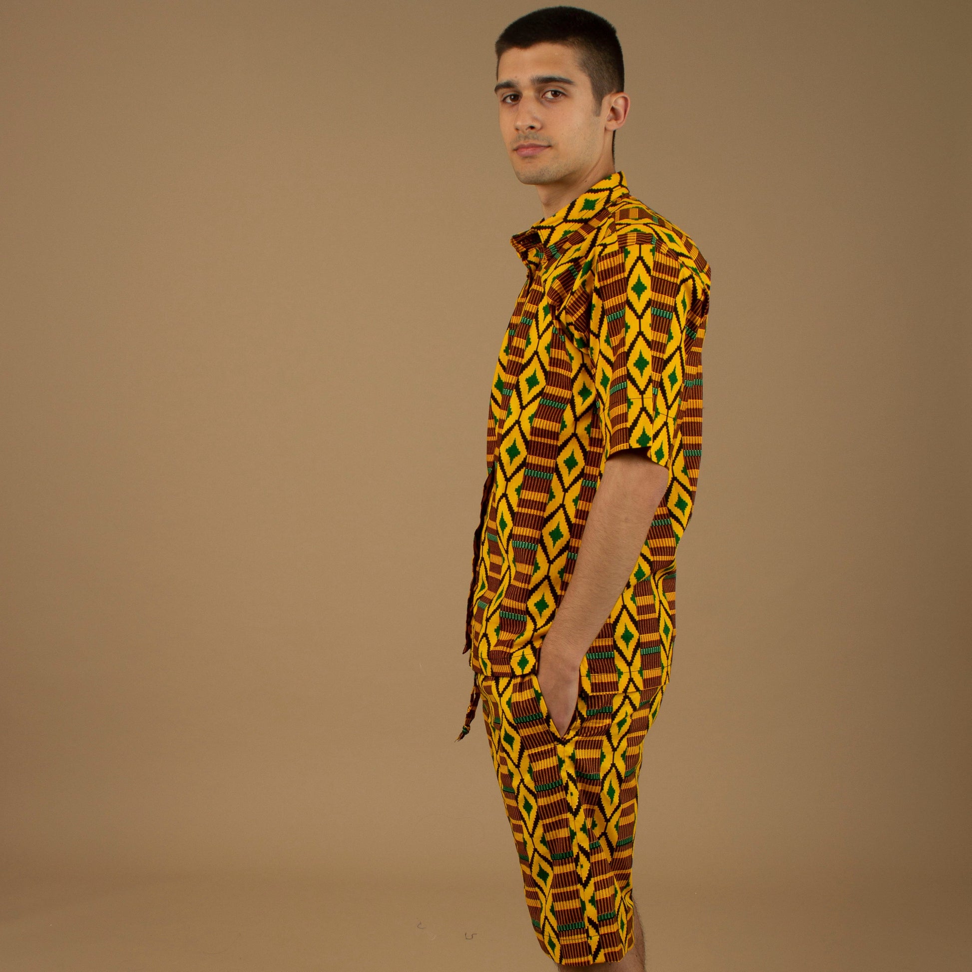 The Adina Kente African Print two- piece Button-Up shirt and Shorts in a striking Diamond geometric kente pattern in  green, yellow and black made from sustainably sourced 100% Cotton. Designed in England Made in Nigeria.