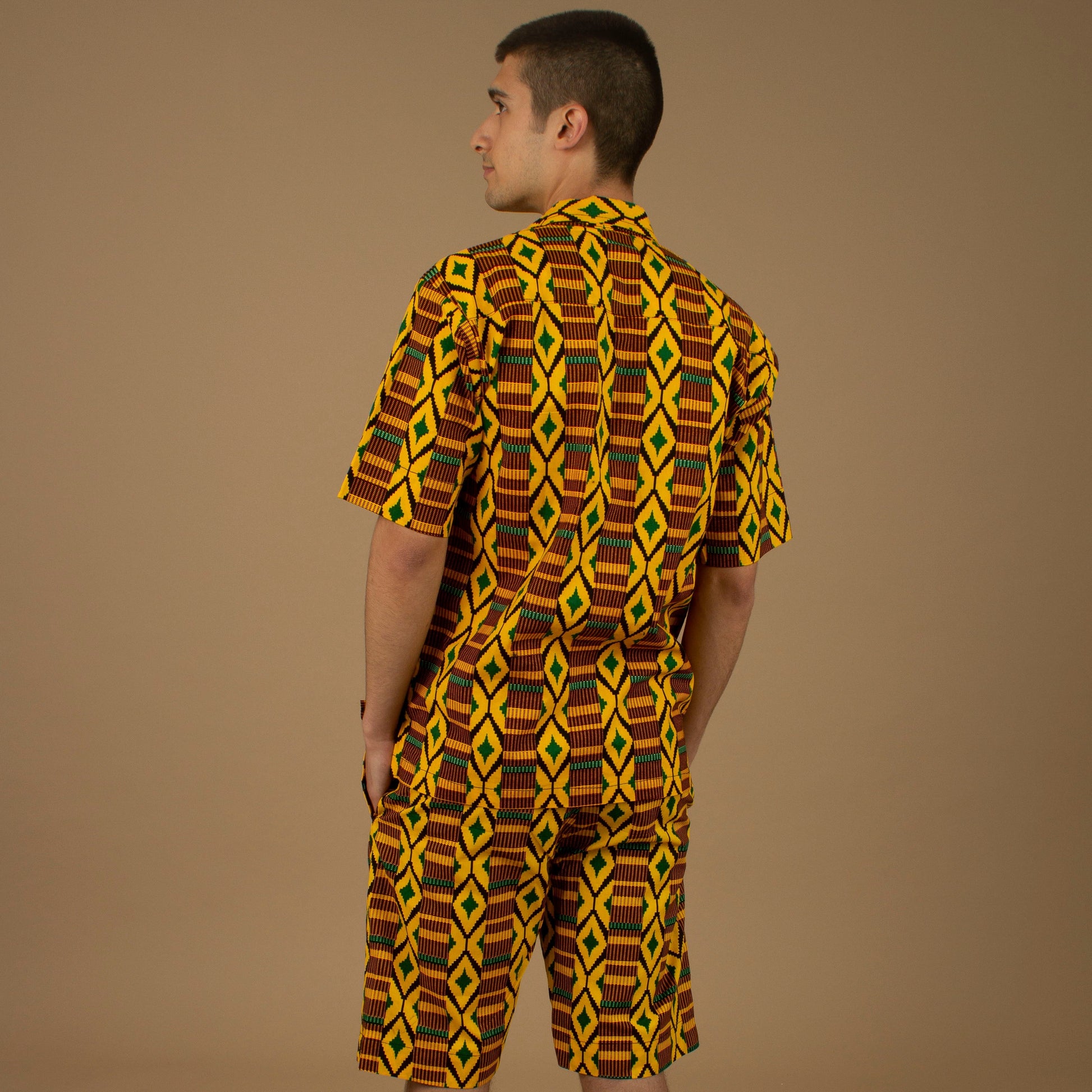 The Adina Kente African Print two- piece Button-Up shirt and Shorts in a striking Diamond geometric kente pattern in  green, yellow and black made from sustainably sourced 100% Cotton. Designed in England Made in Nigeria.