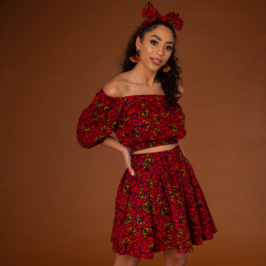 Red, yellow and black African print high waisted pleated skater skirt in a floral pattern, made from sustainably sourced Ankara wax print.