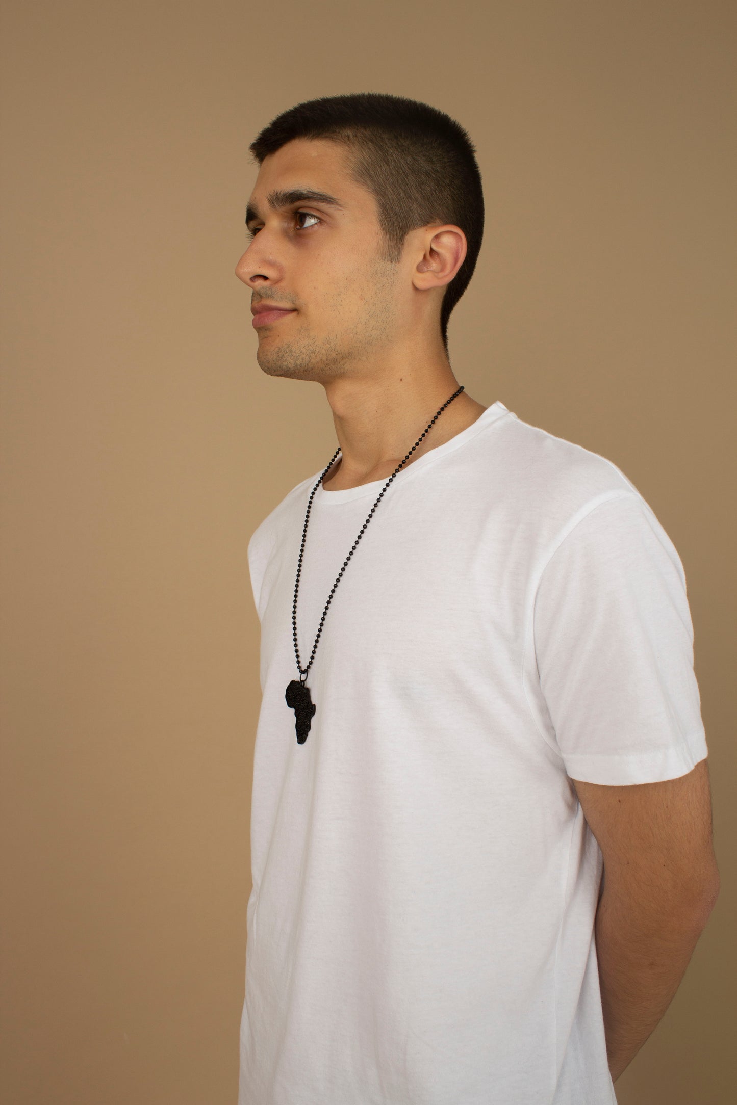 Unisex necklace with a African Map pendant featuring black metallic textured detailing and a metallic chain link. Available in one-size, Designed in England Made in Nigeria.