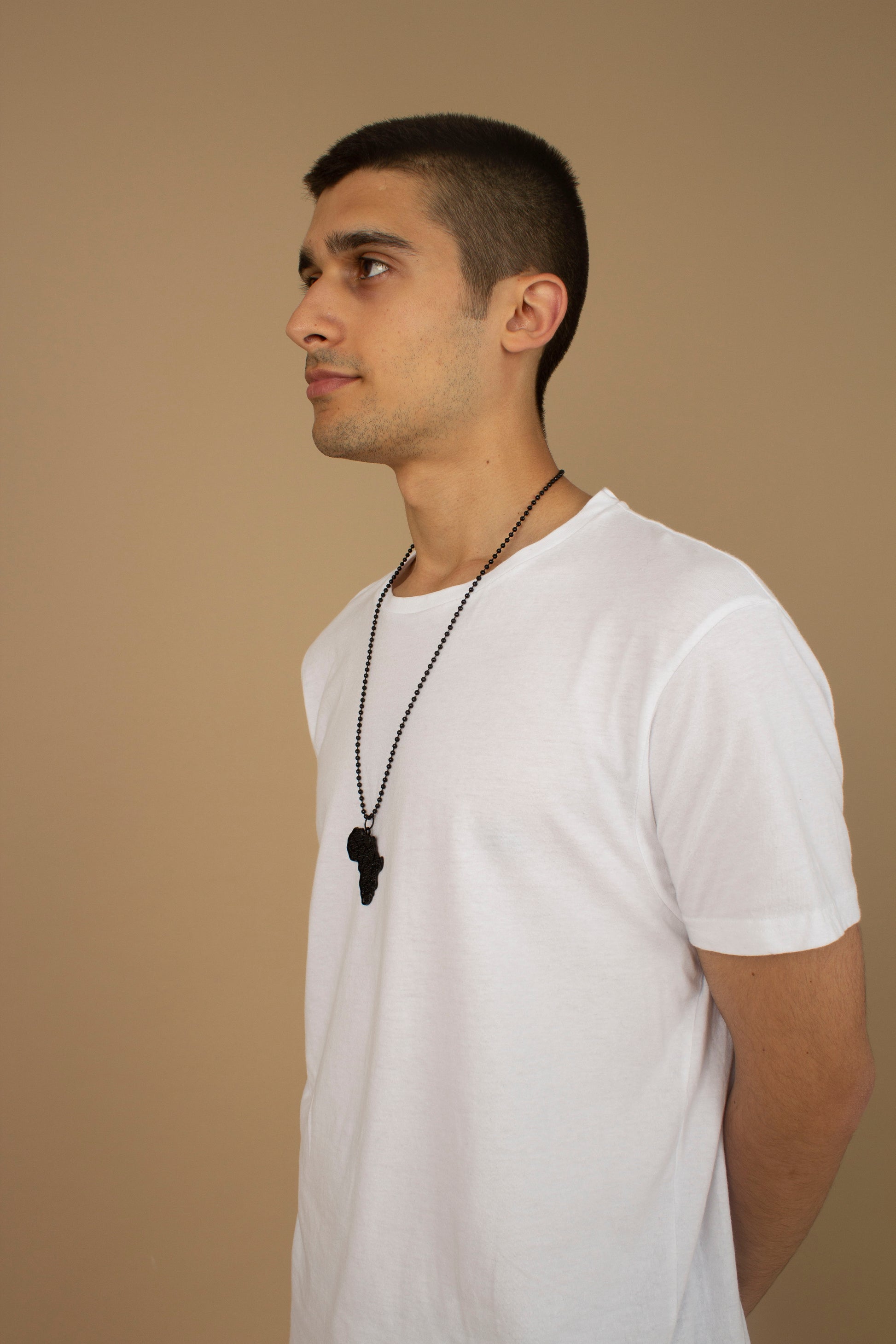 Unisex necklace with a African Map pendant featuring black metallic textured detailing and a metallic chain link. Available in one-size, Designed in England Made in Nigeria.