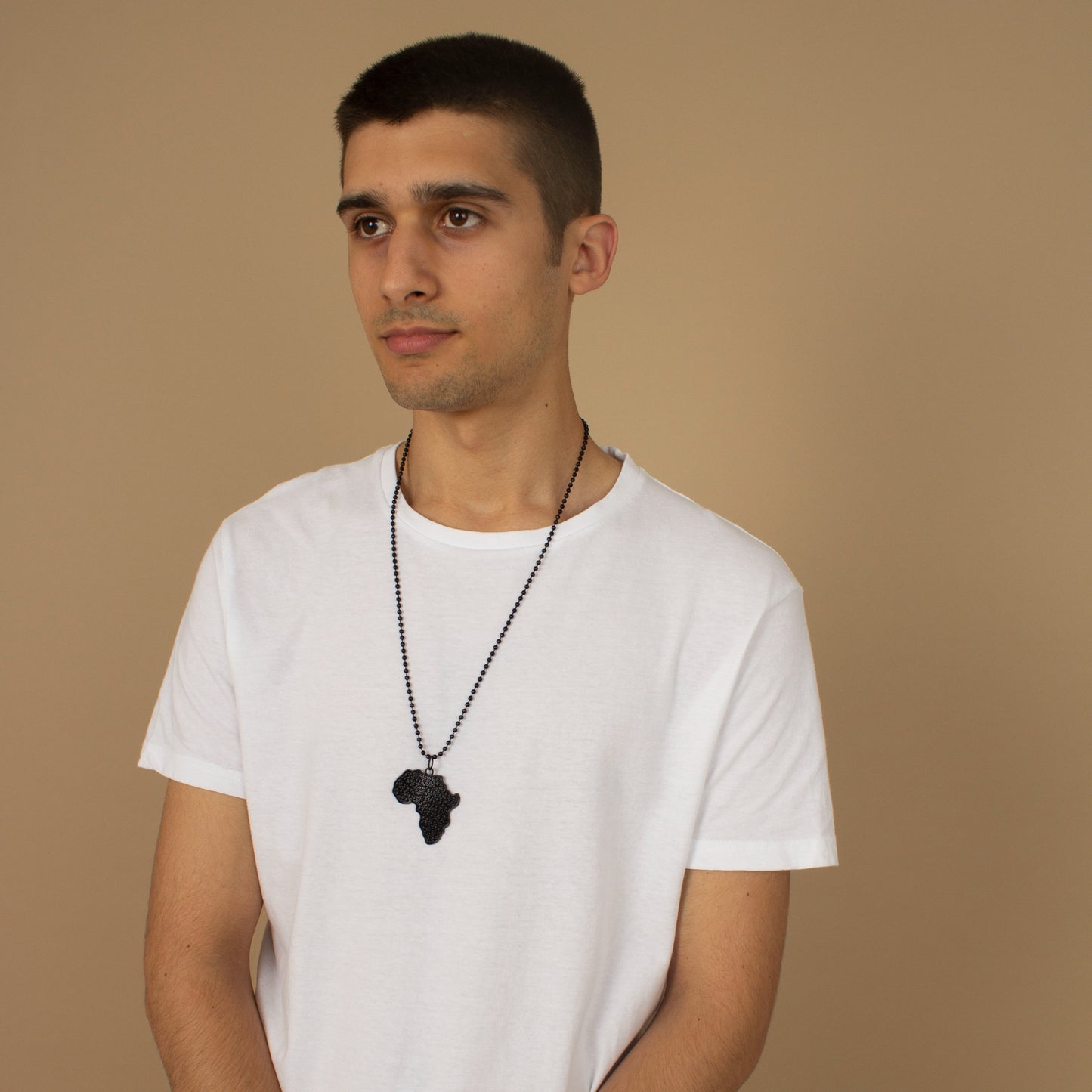 Unisex necklace with a African Map pendant featuring black metallic textured detailing and a metallic chain link. Available in one-size, Designed in England Made in Nigeria.