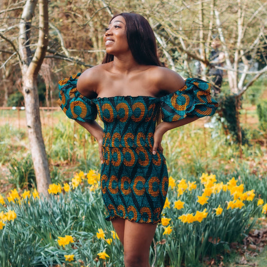 Adetayo African Ankara wax printed fabric in a green, orange and black circle geo-shaped pattern featured Midi-length dress, off-shoulder puff sleeve wit fitted bodice with a fitted elasticated waist reverse and closed back.