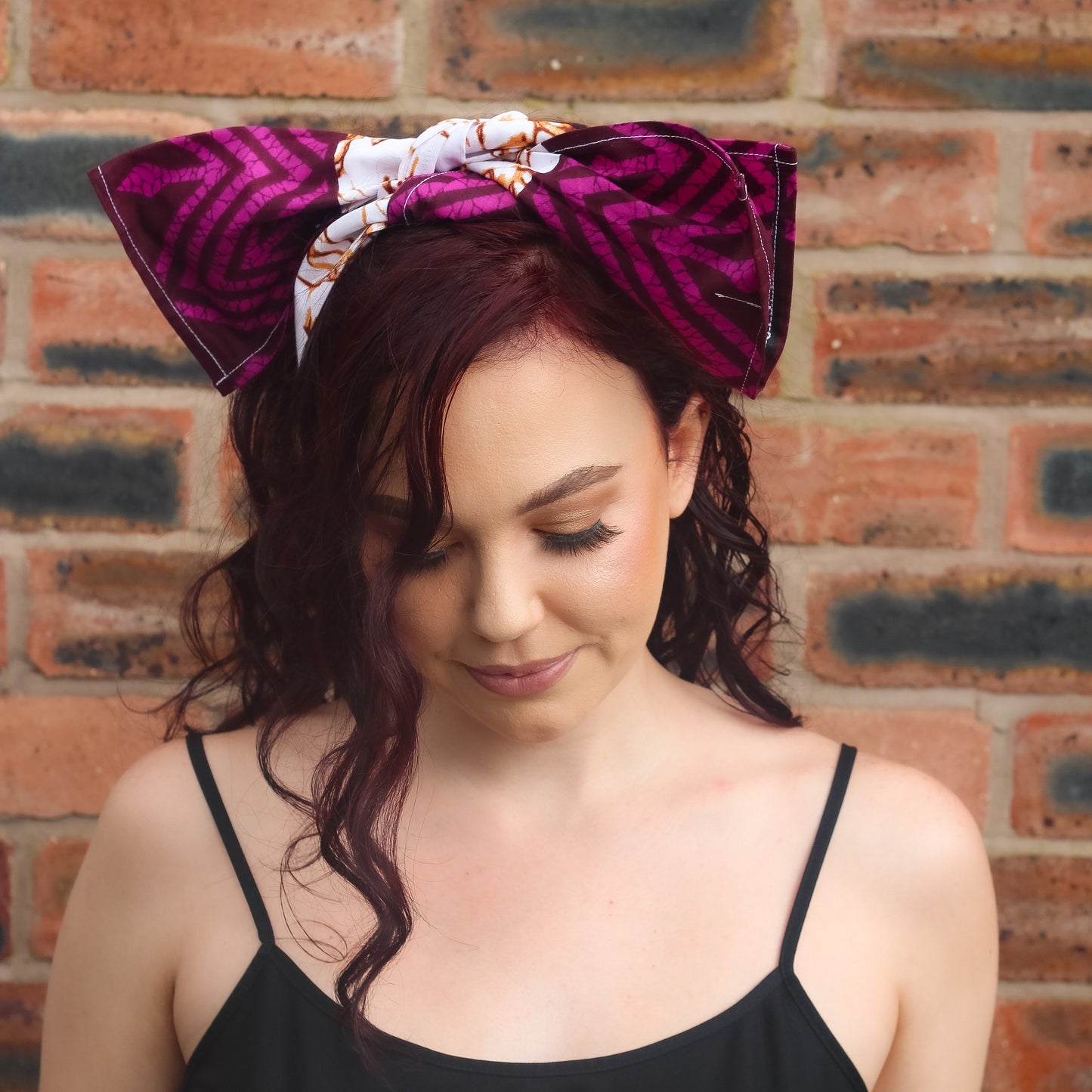 Purple, brown, and white African print head wrap tied as headband in a granite pattern, made from sustainably sourced Ankara wax print. 