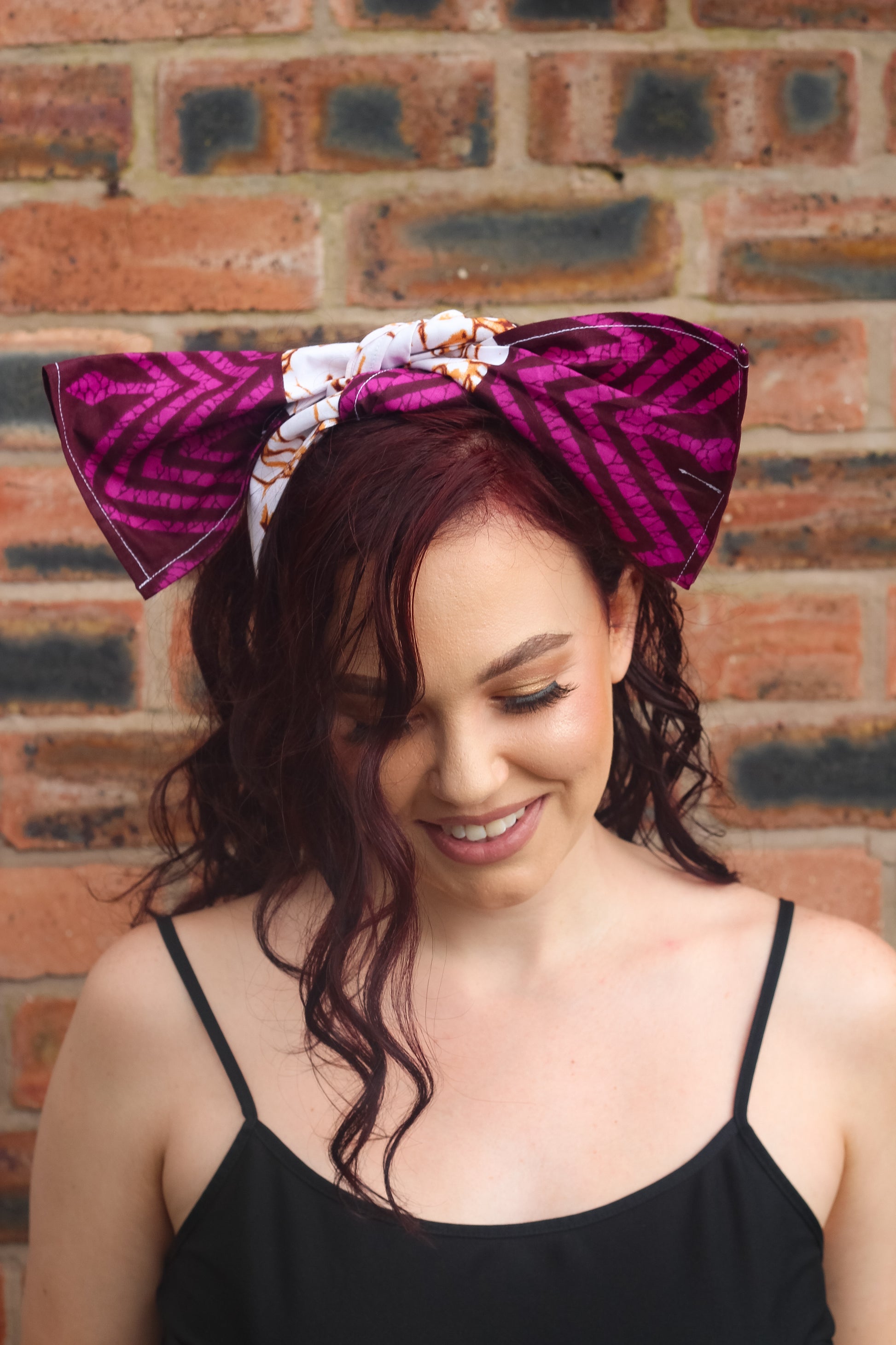 Purple, brown, and white African print head wrap tied as headband in a granite pattern, made from sustainably sourced Ankara wax print. 