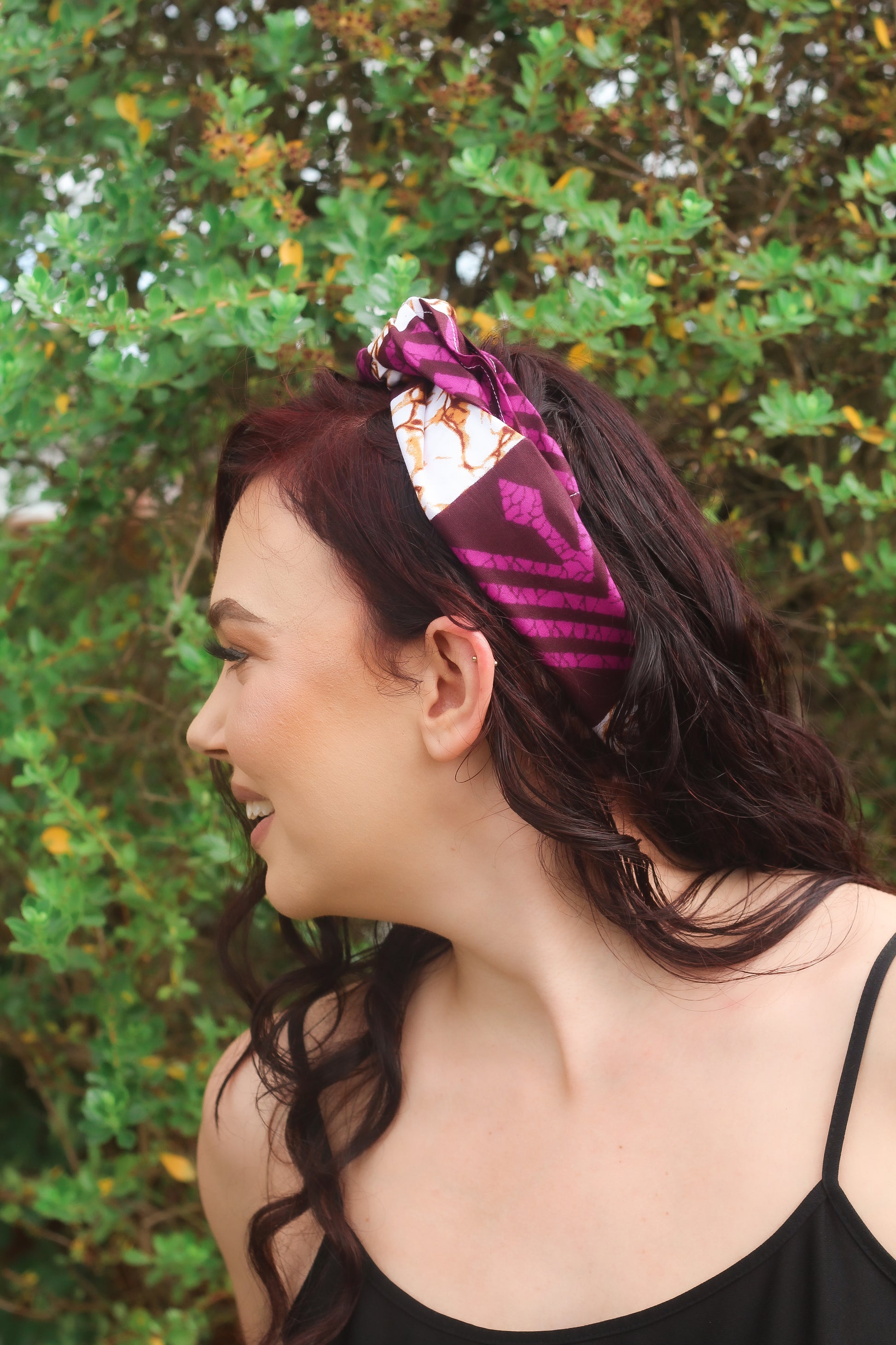 Purple, brown, and white African print head wrap tied as headband in a granite pattern, made from sustainably sourced Ankara wax print. 