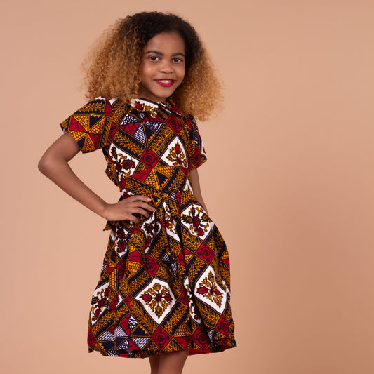  Ankara wax printed Knee length flared belted  dress with short sleeves and collared neckline in Red, yellow, white and black Squared African medallion pattern.