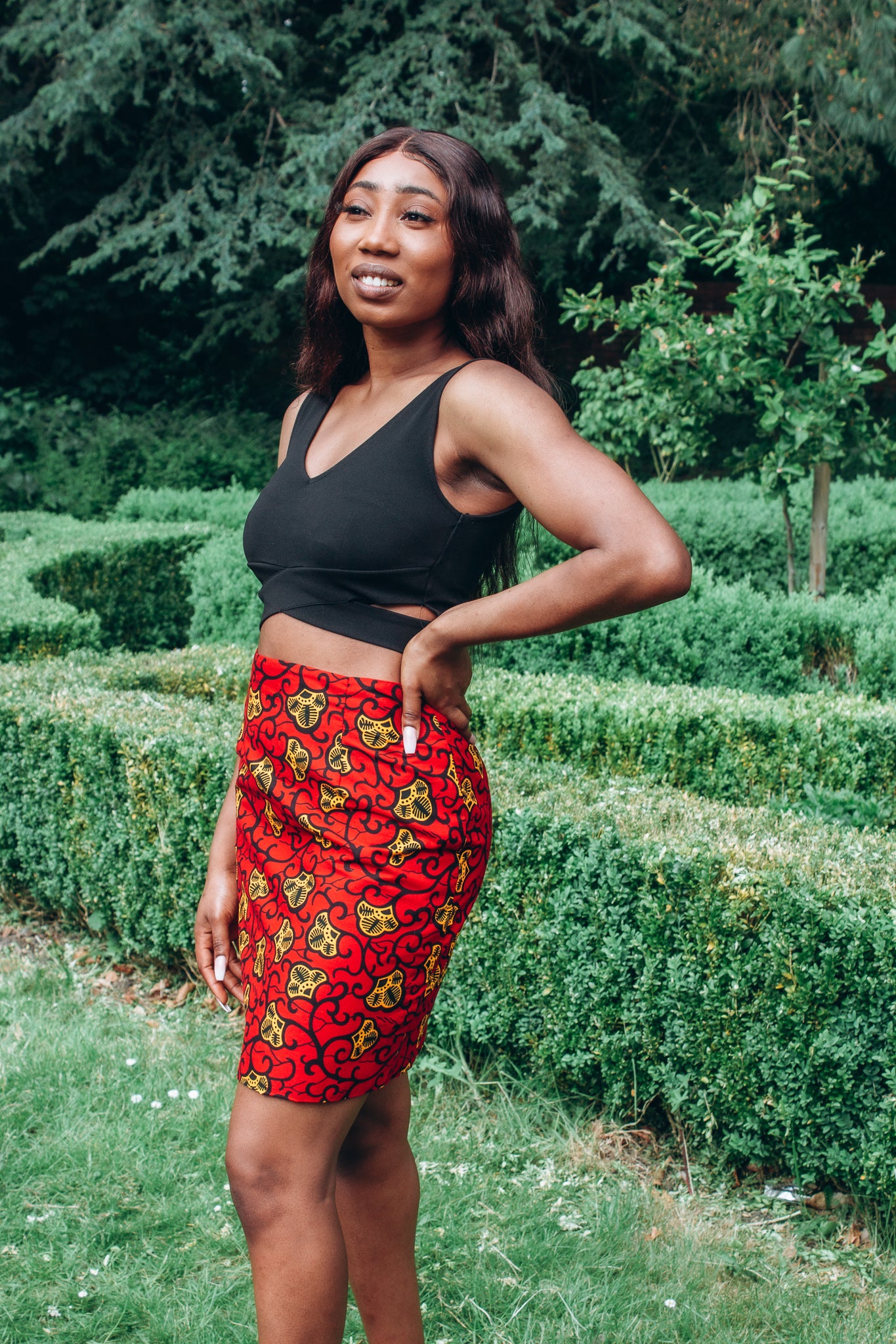Red, yellow and black African print high waisted pencil skirt in a floral pattern, made from sustainably sourced Ankara wax print.