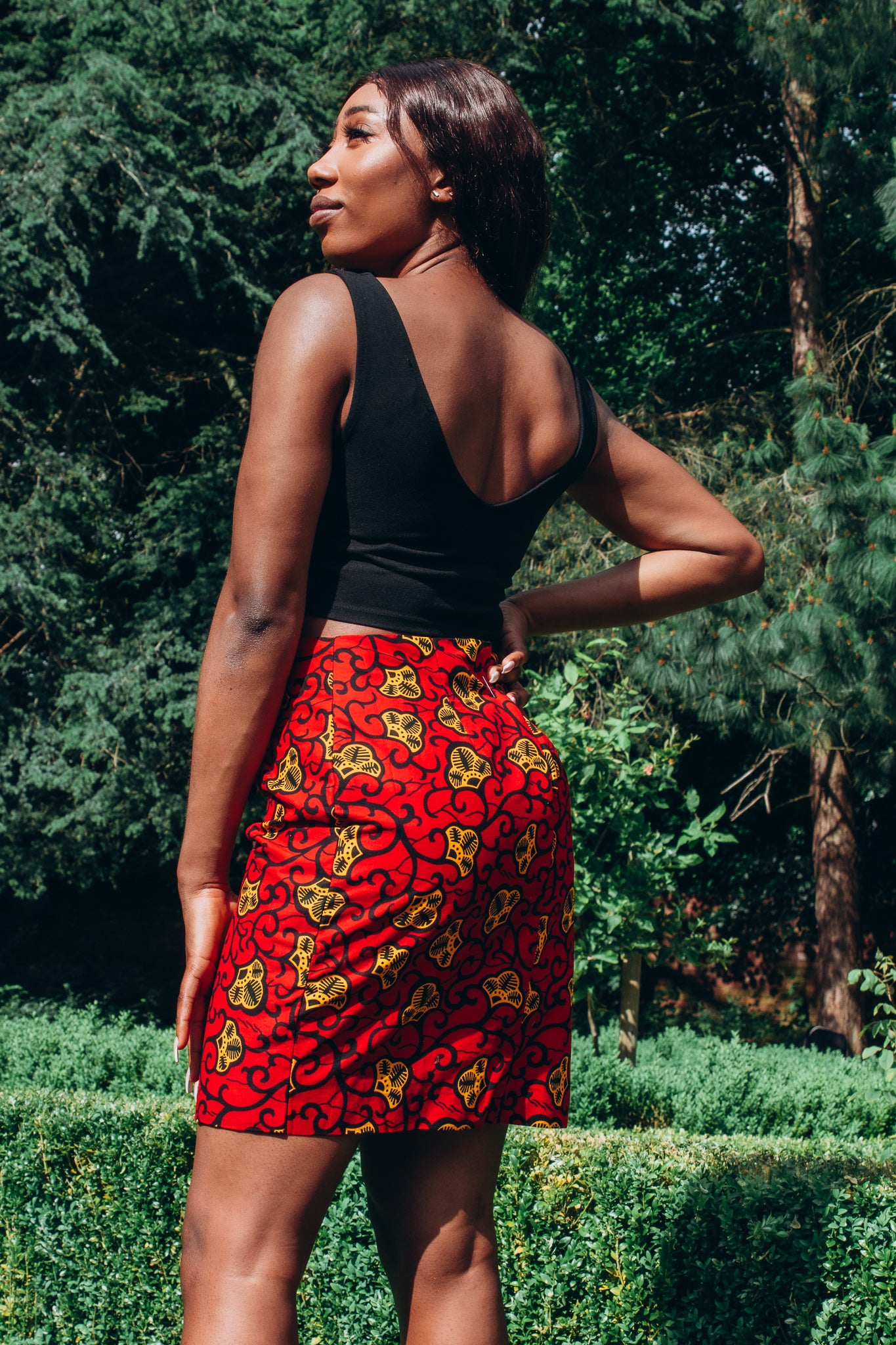 Red, yellow and black African print high waisted pencil skirt in a floral pattern, made from sustainably sourced Ankara wax print.Red, yellow and black African print high waisted pencil skirt in a floral pattern, made from sustainably sourced Ankara wax print.