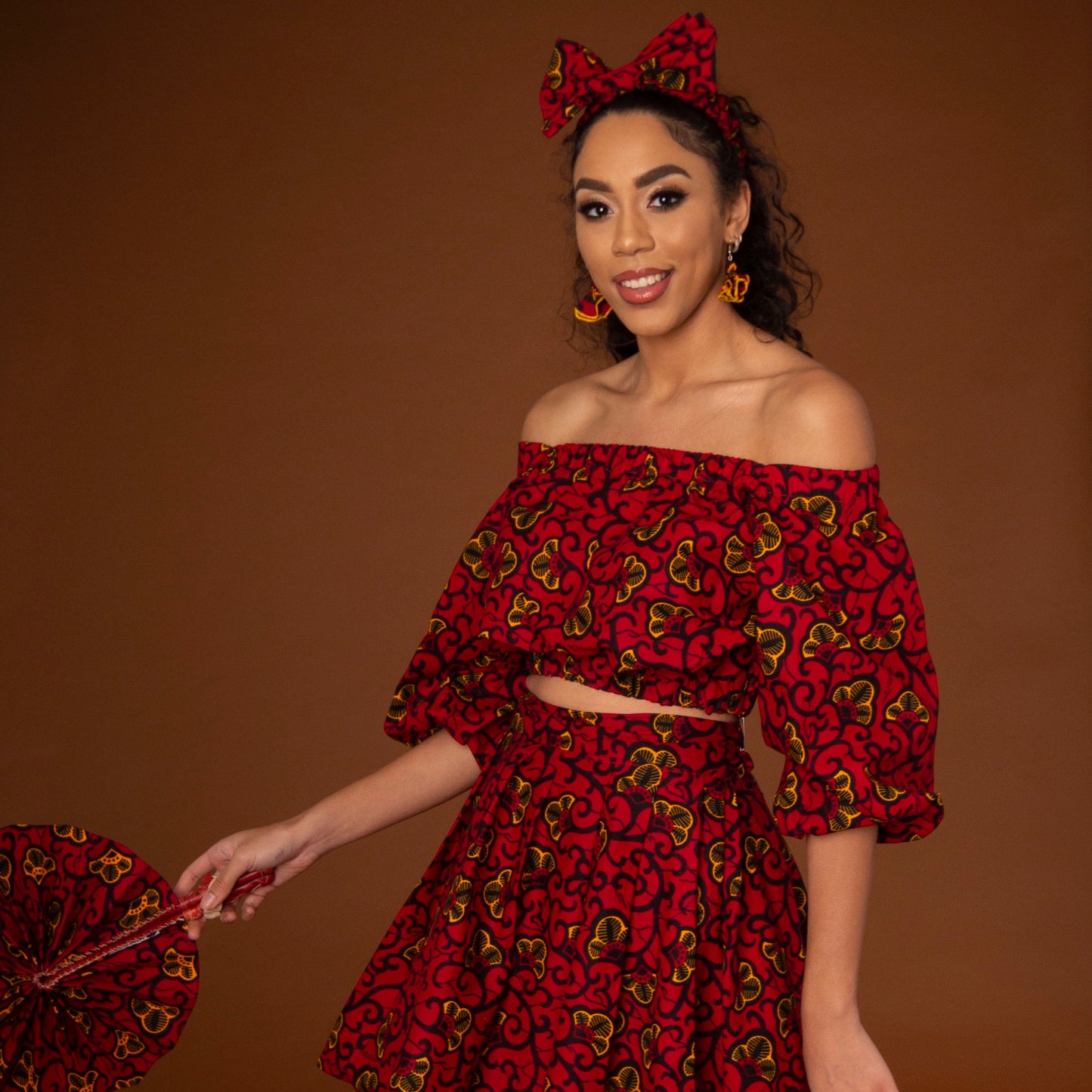African print balloon sleeve crop top and matching high waisted flare skirt a striking red, yellow and black ankara fabric