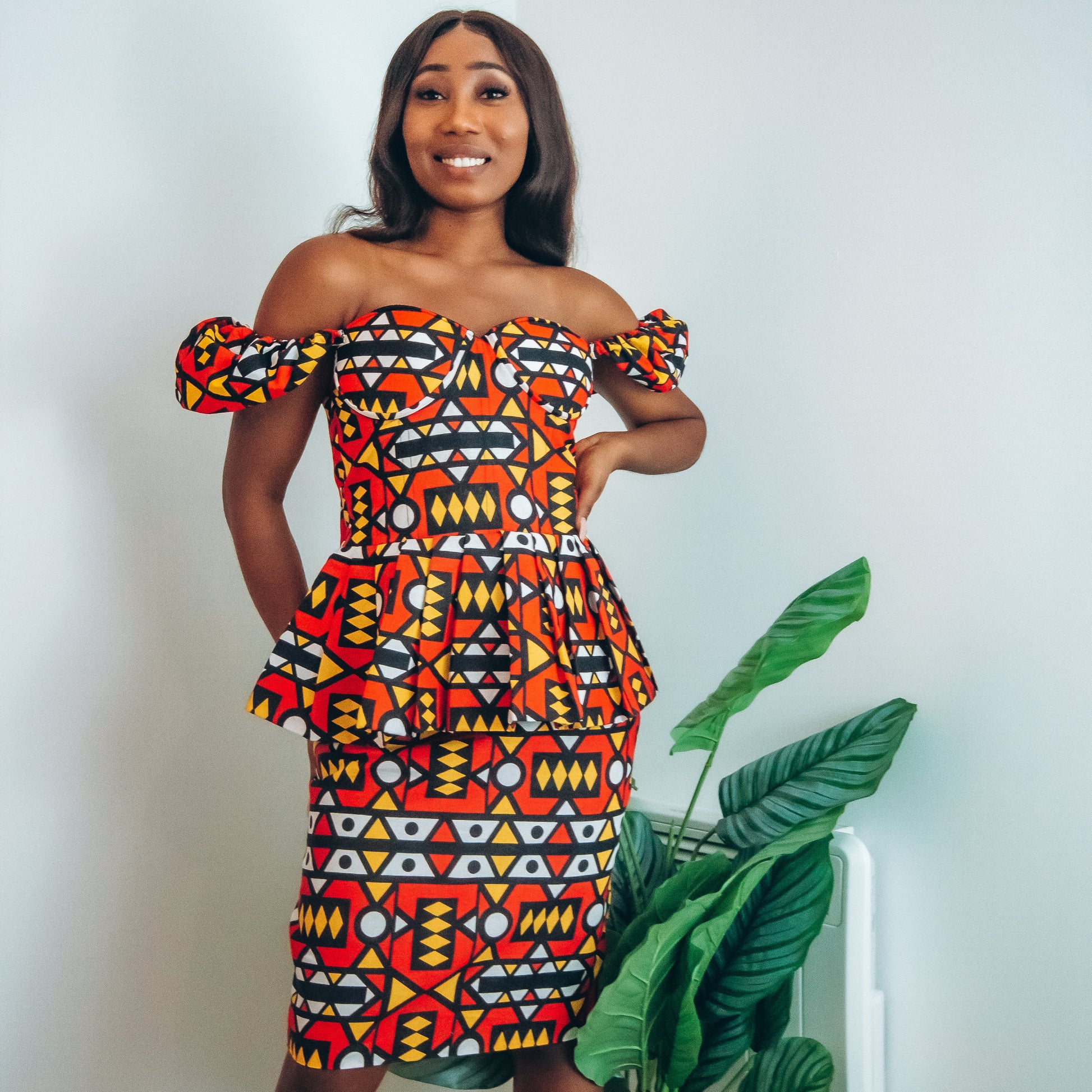 Red, pastel yellow, white and black African printKnee length pencil  skirt, in oversized geo-shaped pattern made from sustainably sourced Ankara wax print