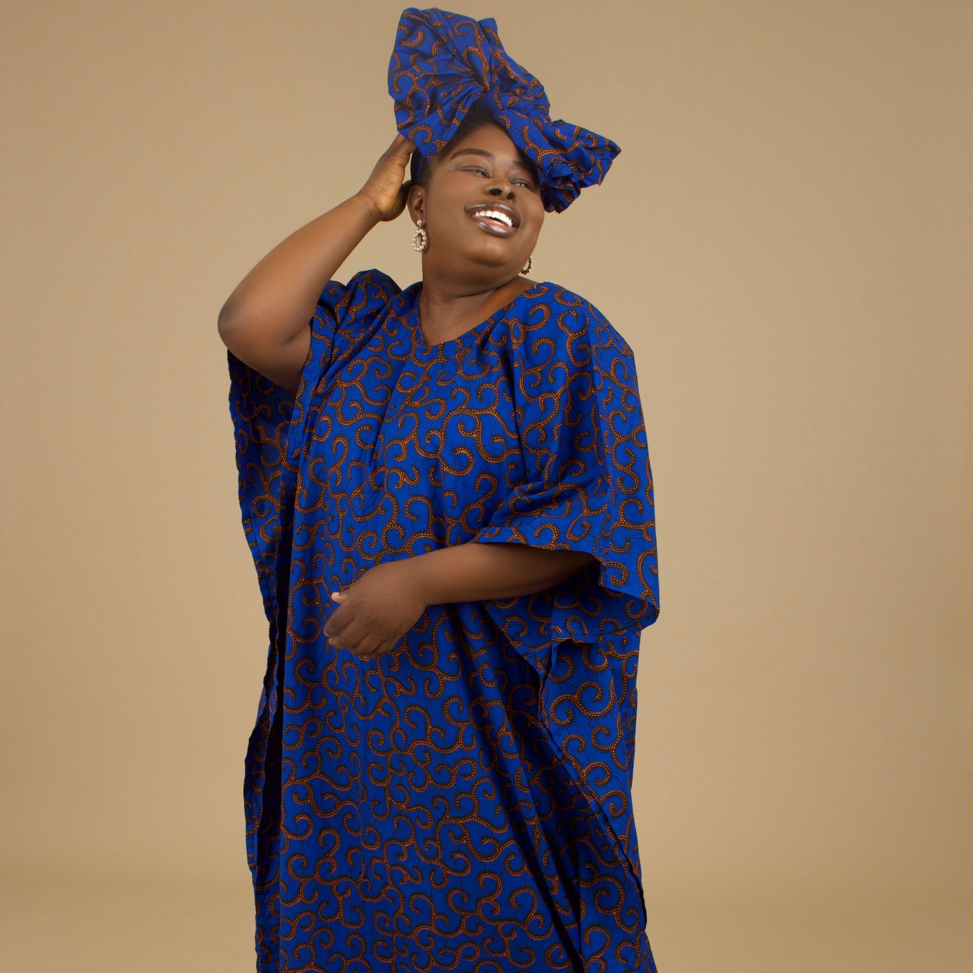 The Ore Floor Length lightweight African Print Kaftan Dress in Ankara wax print in a deep blue and orange swirling African Print pattern is ethically sourced cotton. Designed in England Made in Nigeria. 