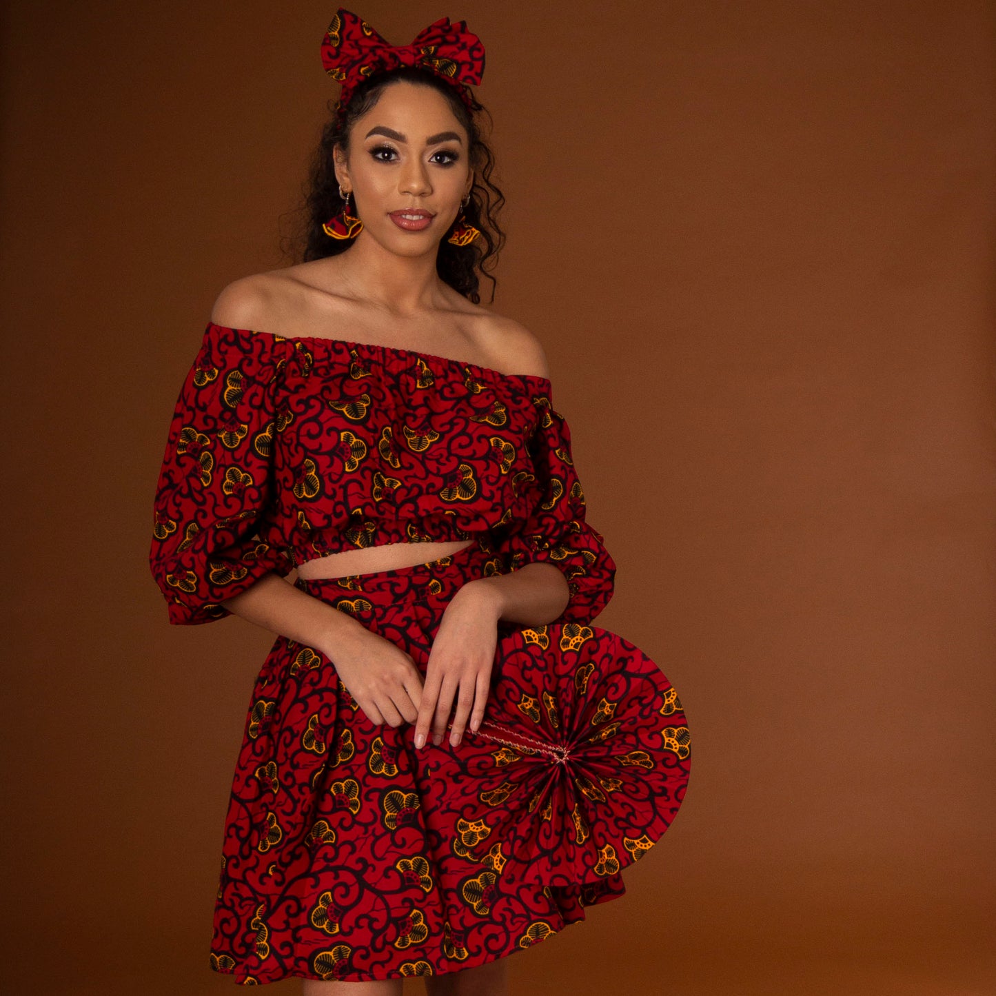 African print balloon sleeve crop top and matching high waisted flare skirt a striking red, yellow and black ankara fabric